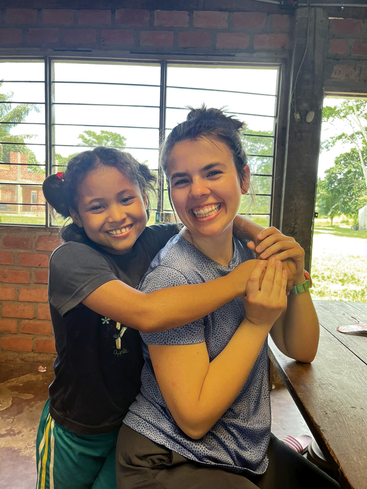 Southern student Alexis Dewey with a child on the Bolivia Vision Trip.