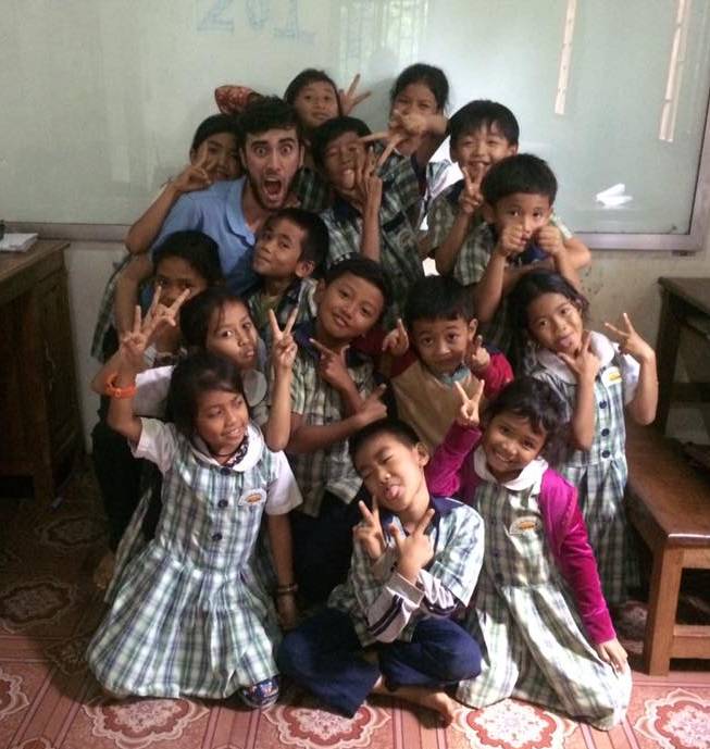 Anthony Nelson surronded by a crowd of children in Cambodia