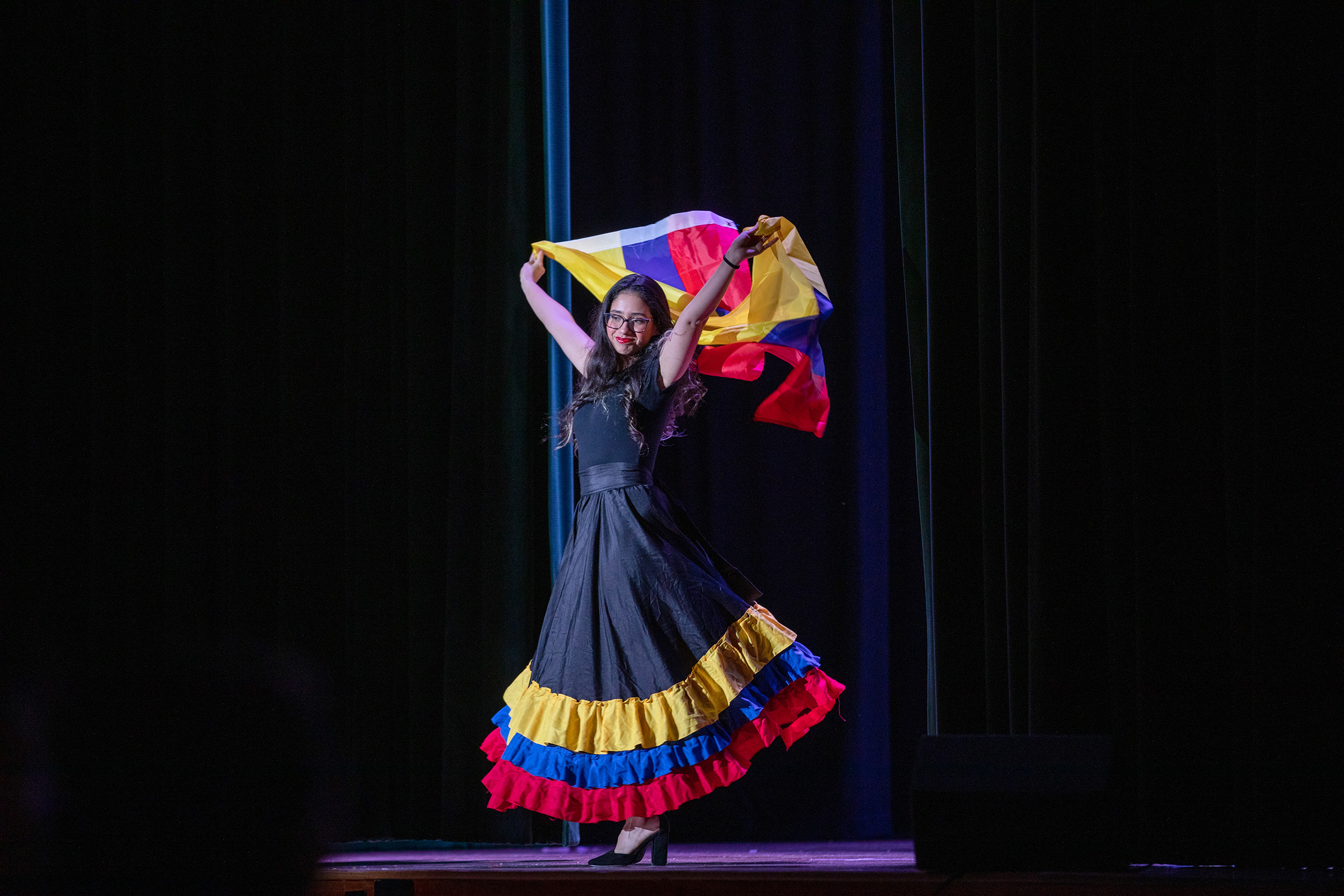 A student at the 2024 Latin American Club night showcases cultural dress and flag.