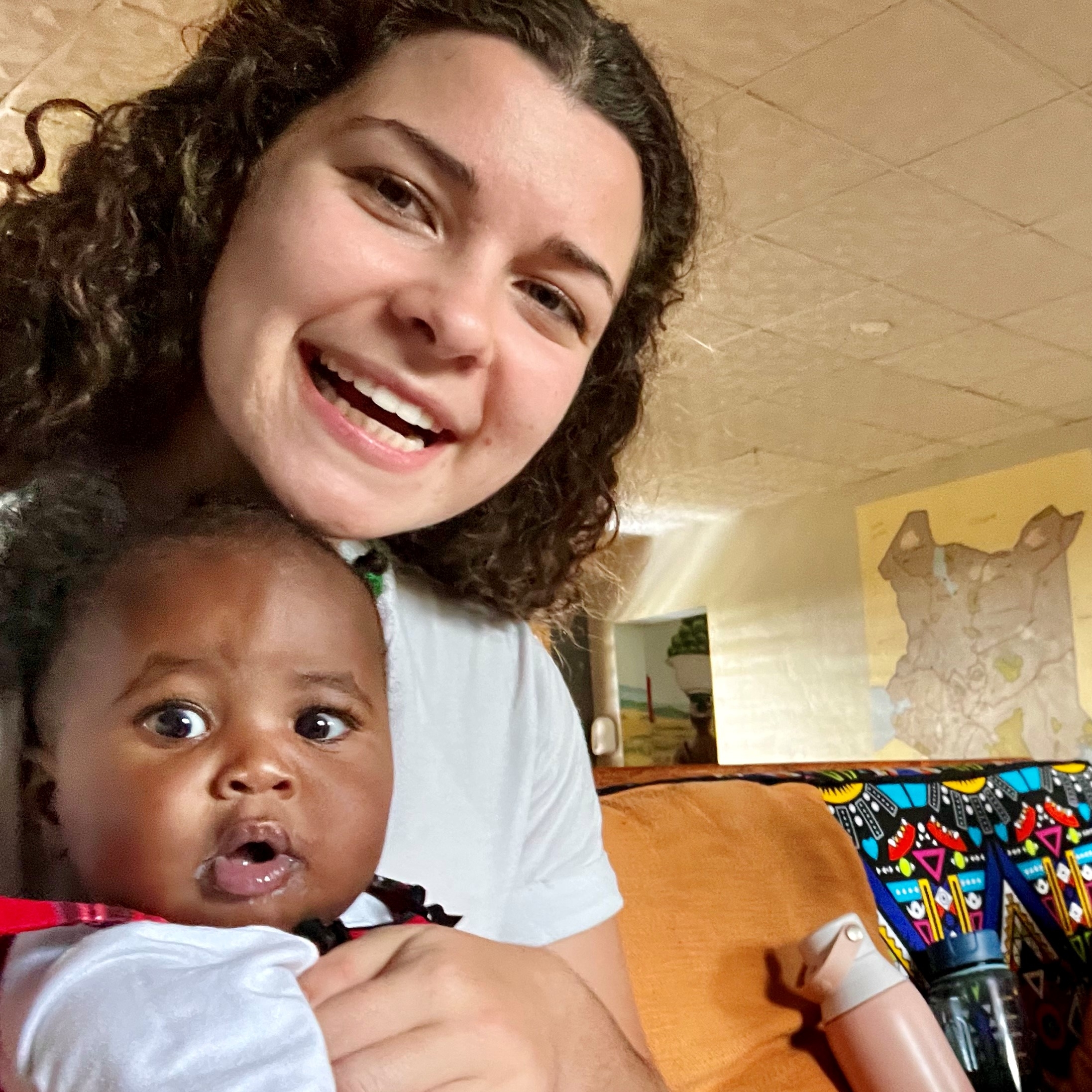 Orphan baby held by student missionary woman in Kenya, Africa