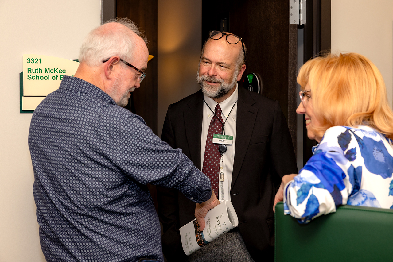 Guests meet with professors at the Ruth McKee School of Business grand opening.