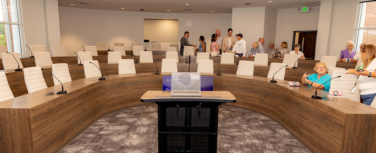 Guests explore the fourth floor board room at the Ruth McKee School of Business grand opening.