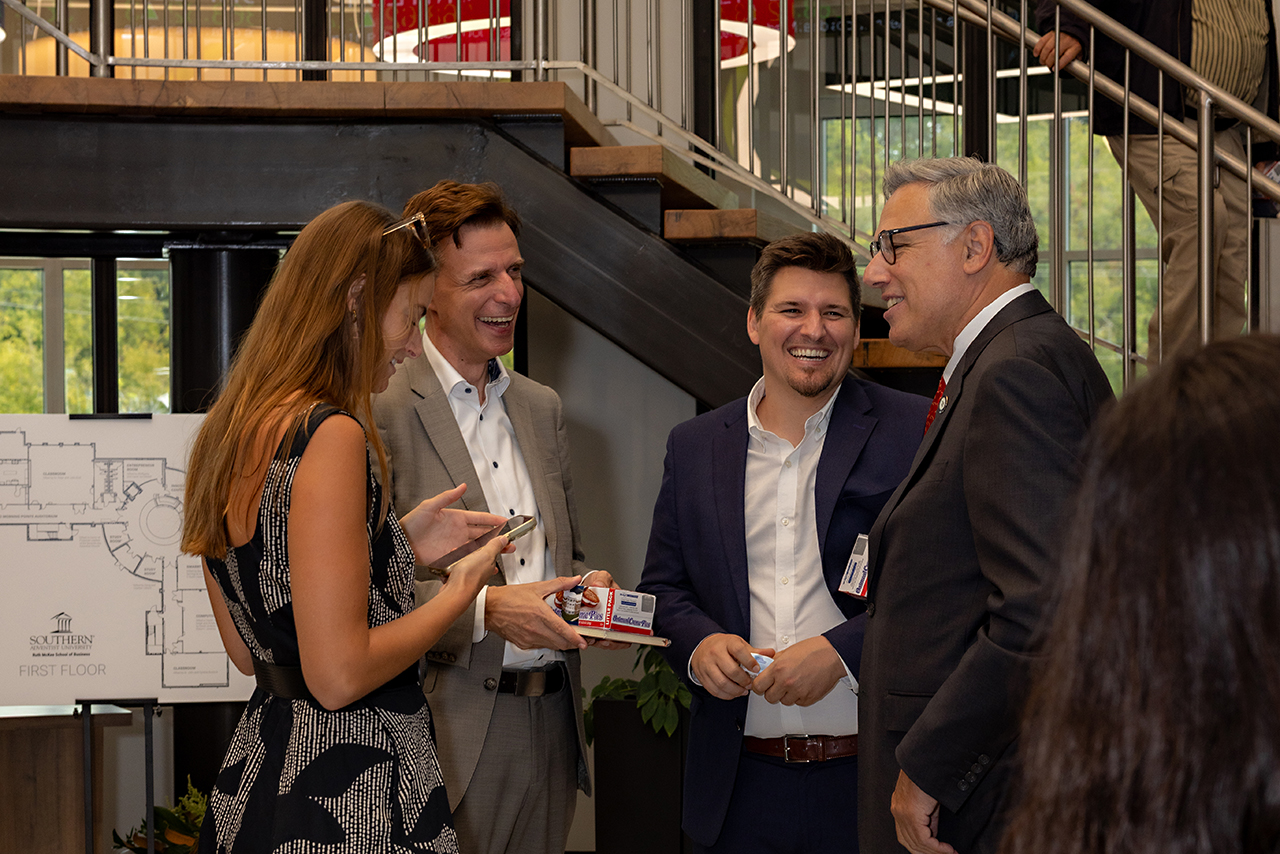 Guests mingle at the Ruth McKee School of Business grand opening.