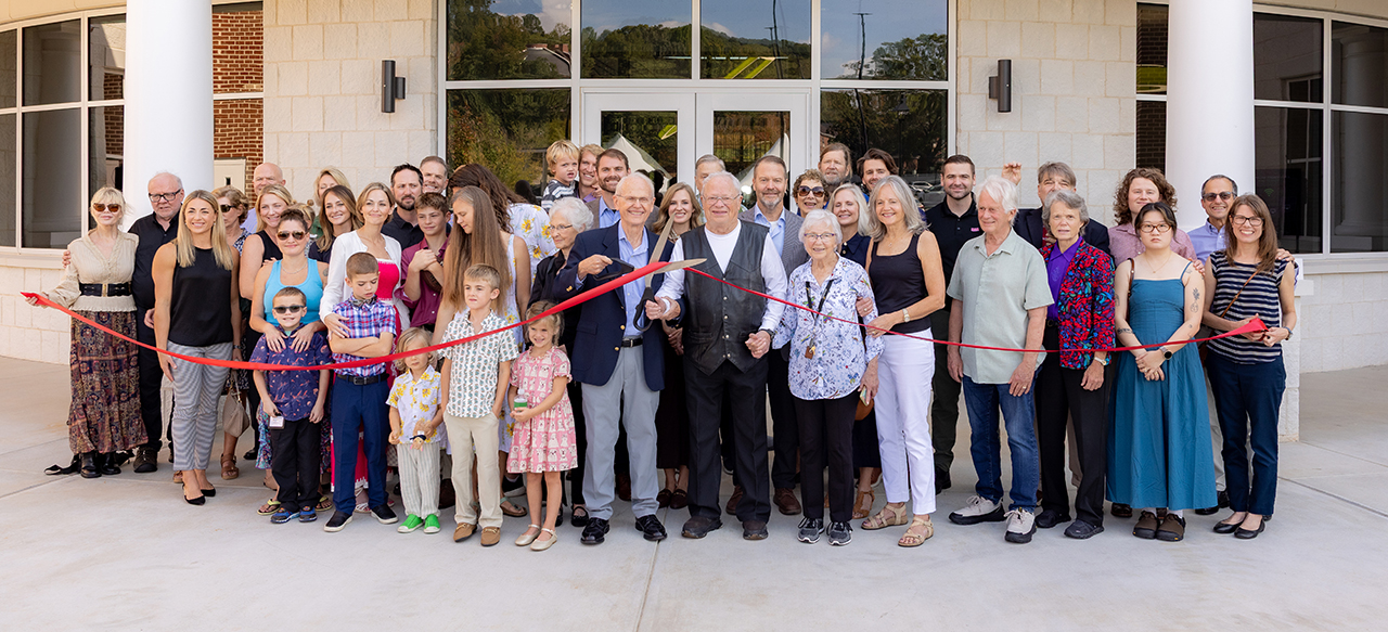 McKee family members gather for a ribbon cutting at the Ruth McKee School of Business grand opening.