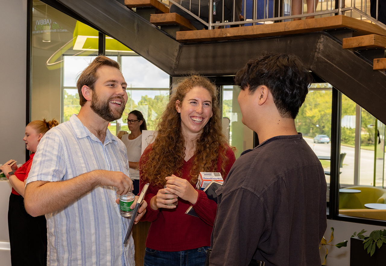 Guests mingle at the Ruth McKee School of Business grand opening.