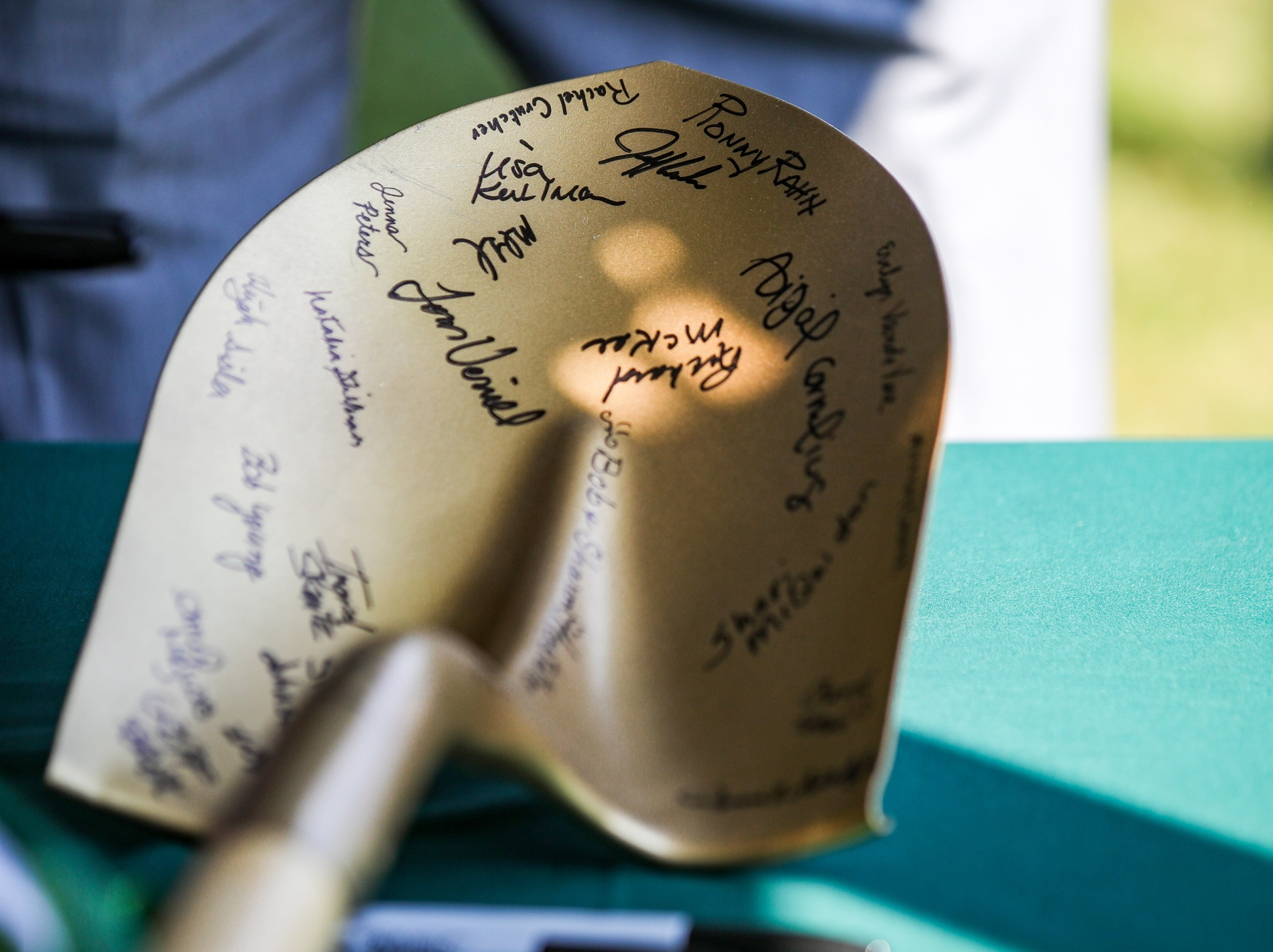 shovel with signatures on it