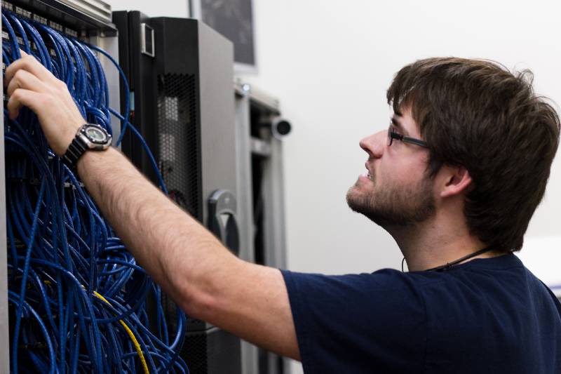IT professional examines wires