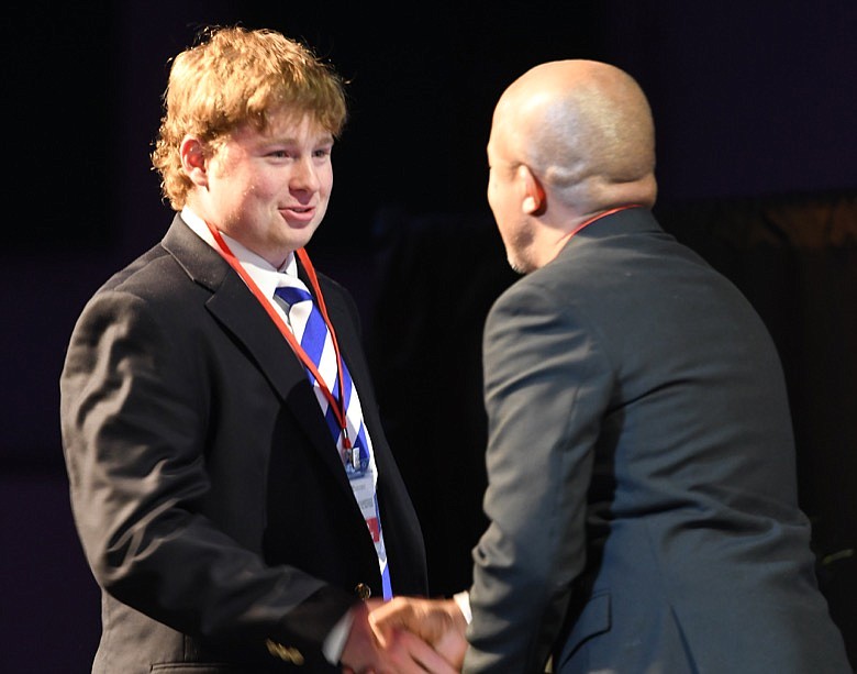 Ethan Met, of McCallie School, receives his Comm Contest Award of $500 in the Vide category from Jason Merryman /©CTFP
