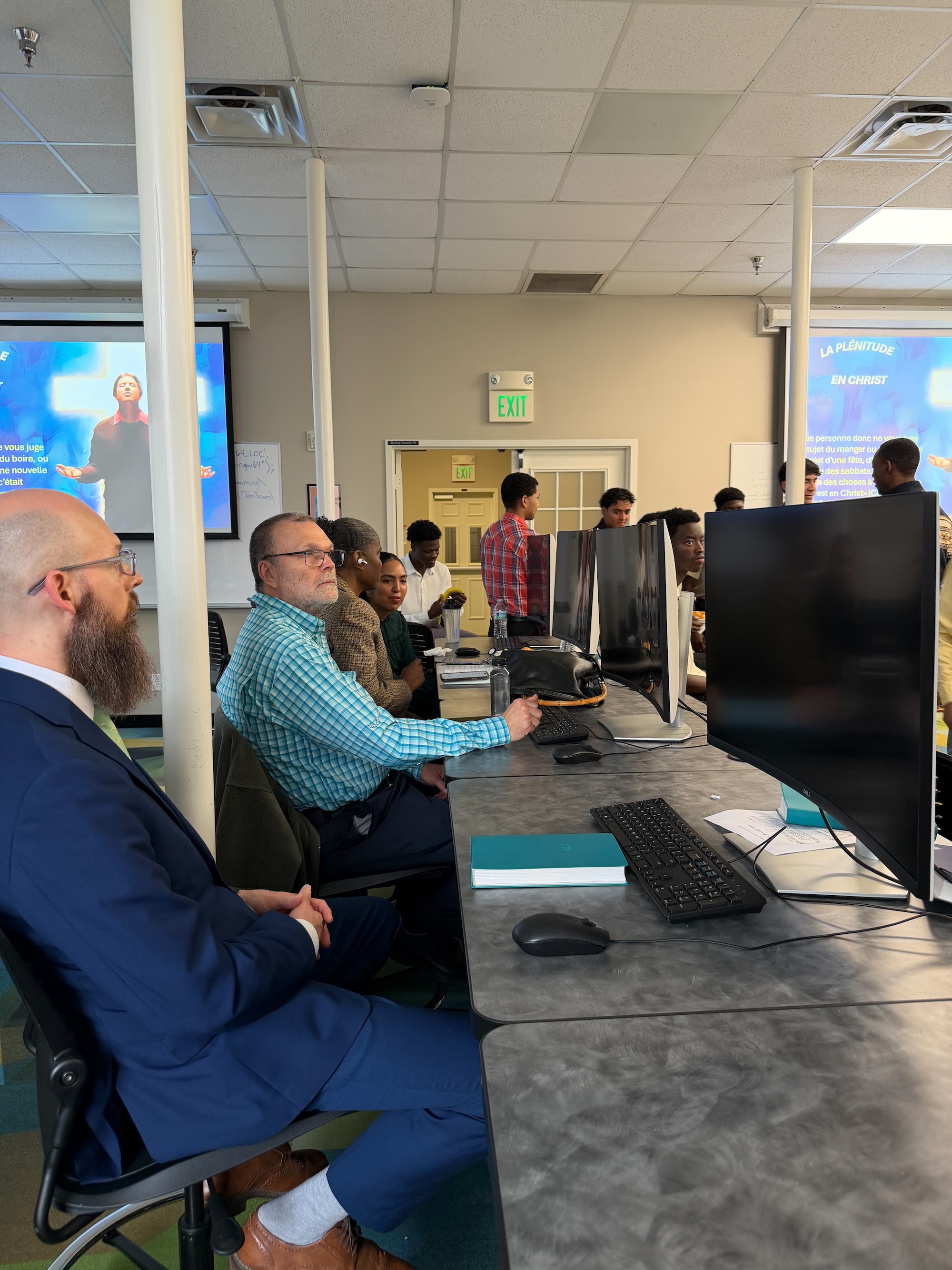 Group attending a Sabbath School discussion in a classroom.