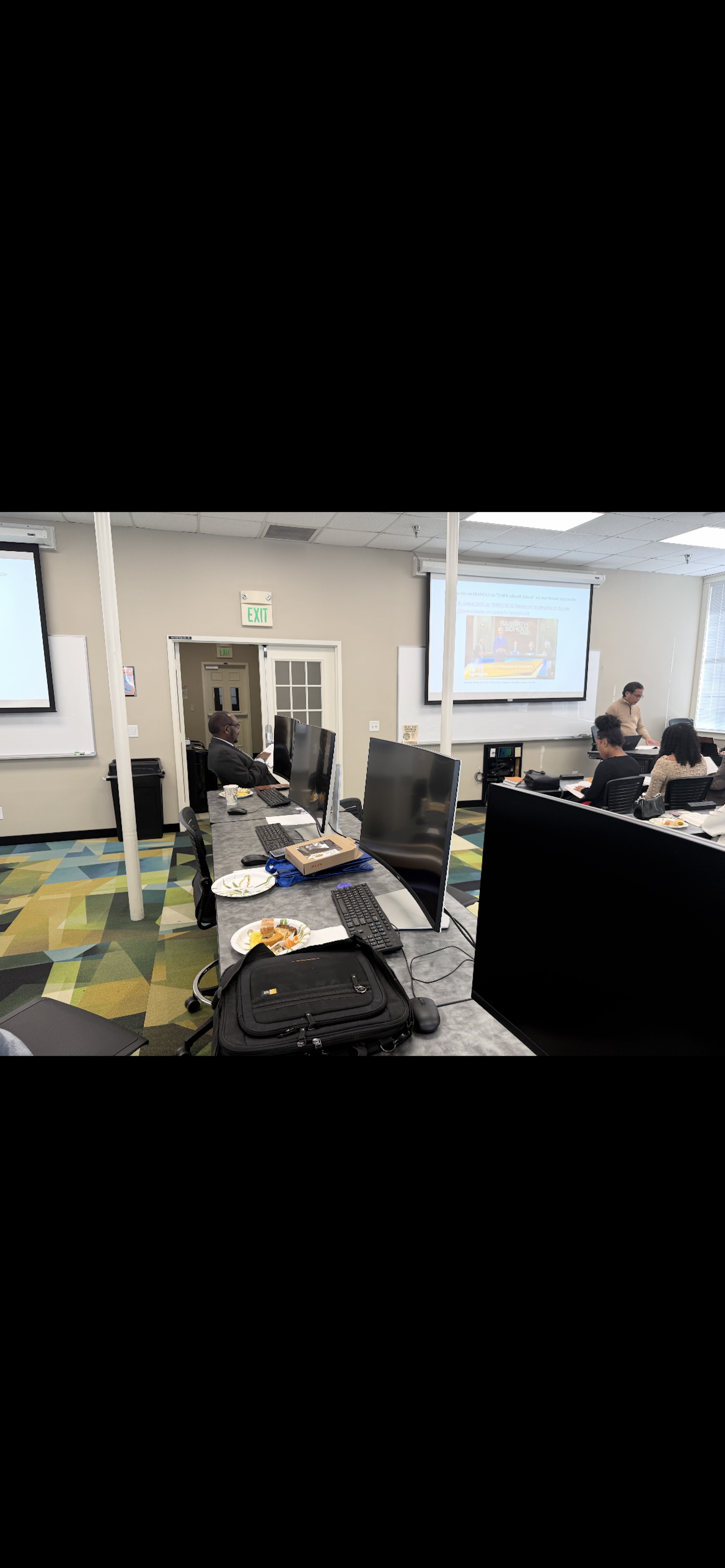 Group attending a Sabbath School discussion in a classroom.