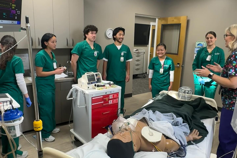 Students standing around simulator