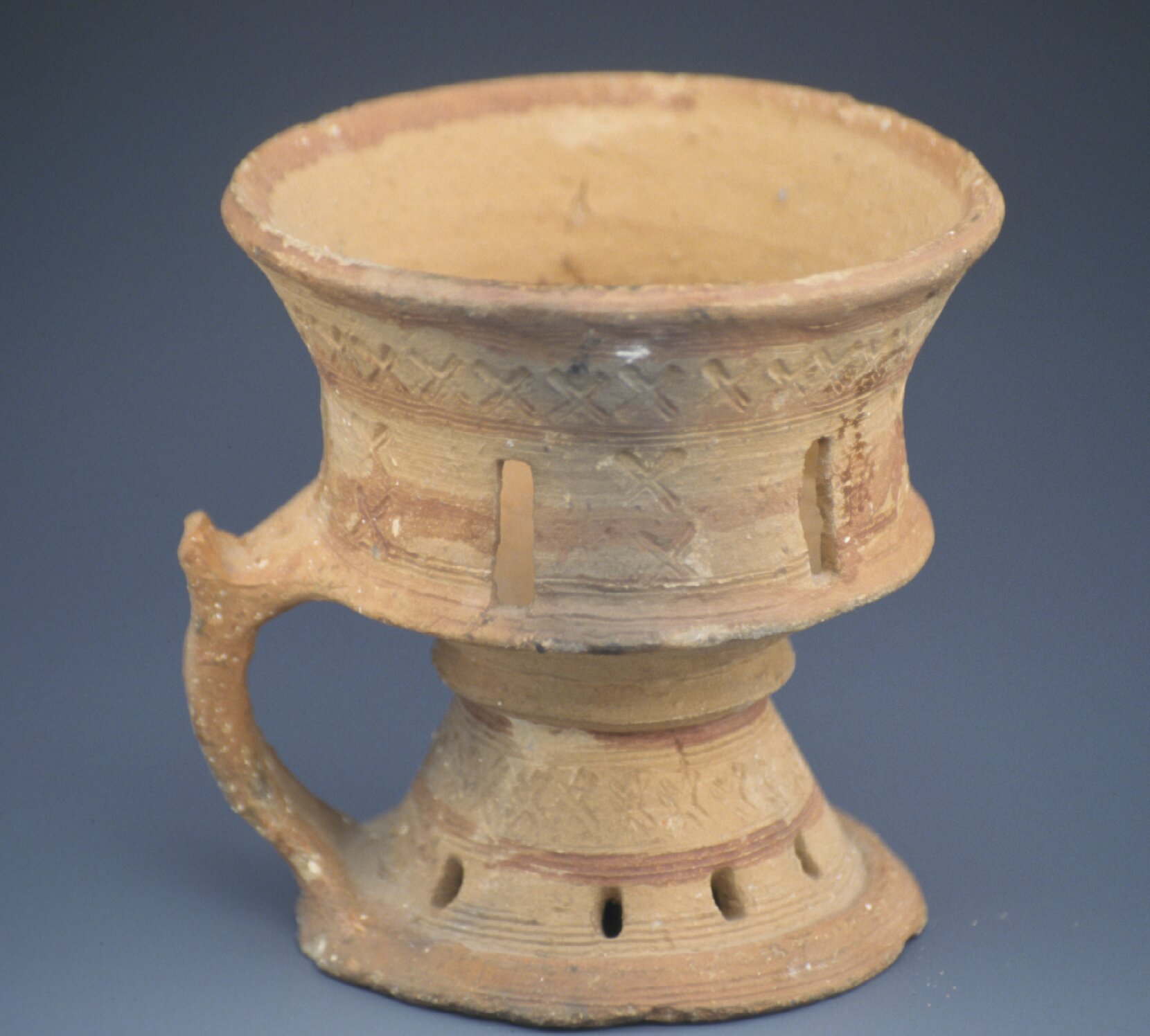 Censor with red paint, impressed design, singular handle