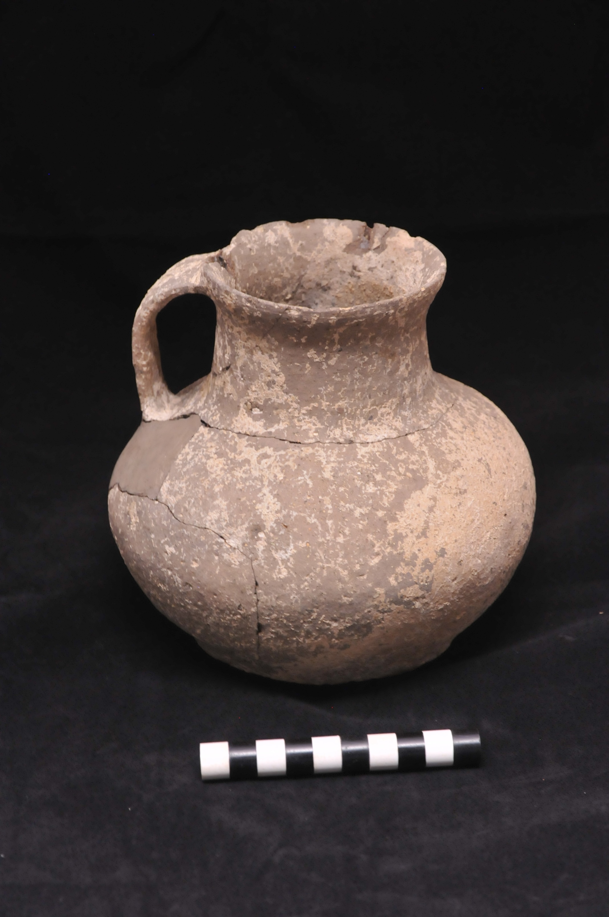 a beige pitcher with one handle