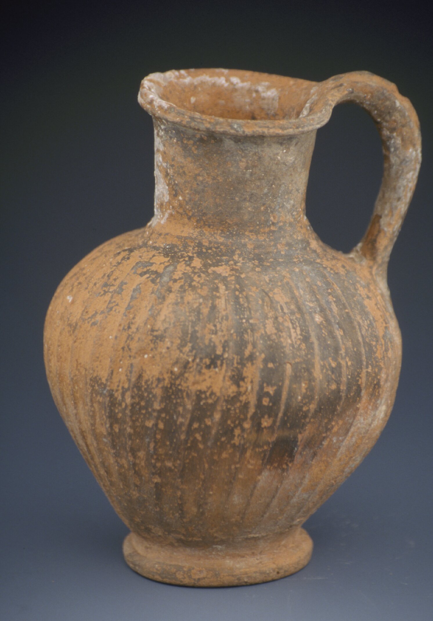 Bucchero ware pitcher, red and black mottled