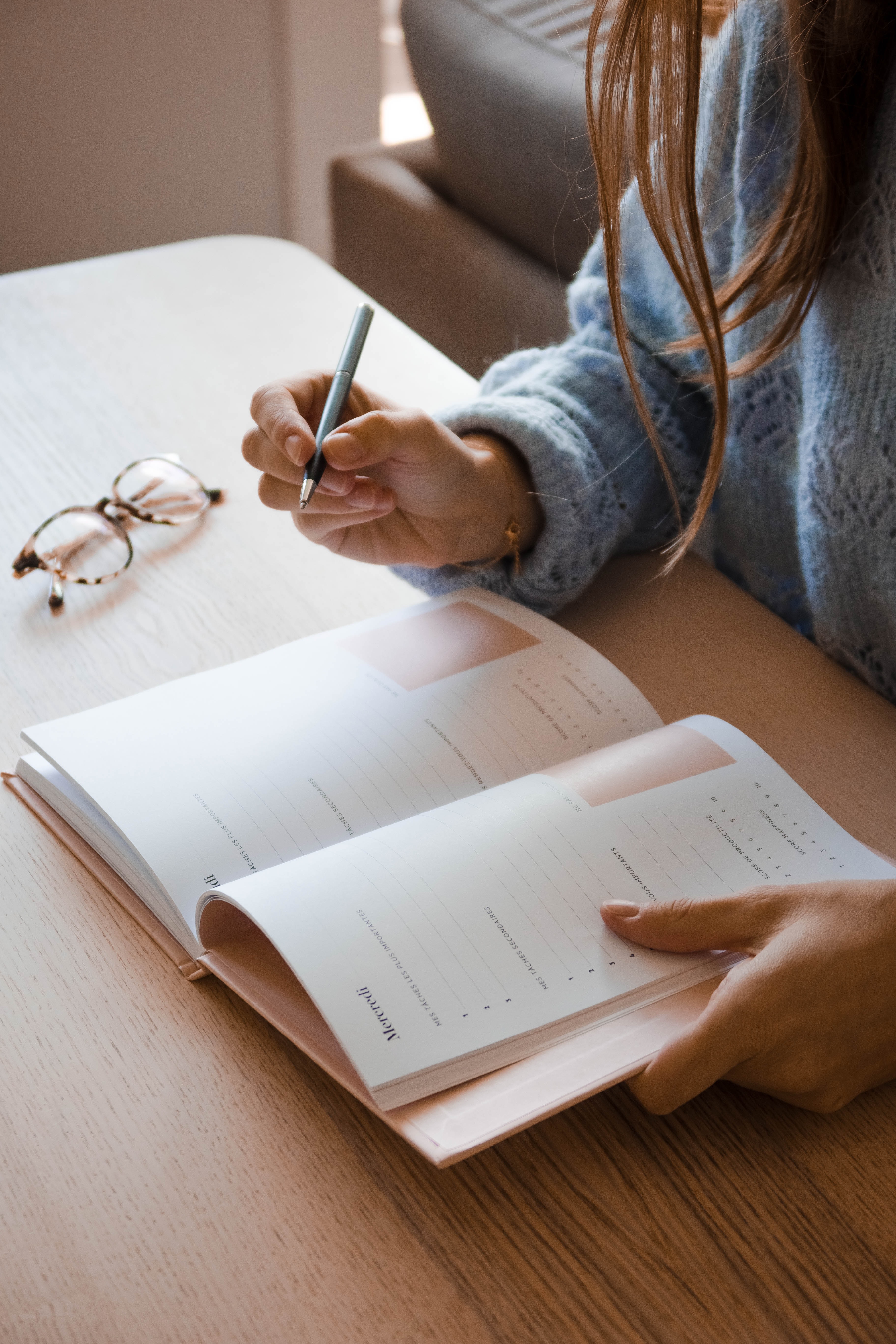 Woman writing in planner