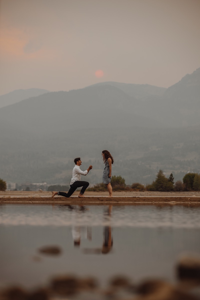 A man proposing to a woman on bended knee.