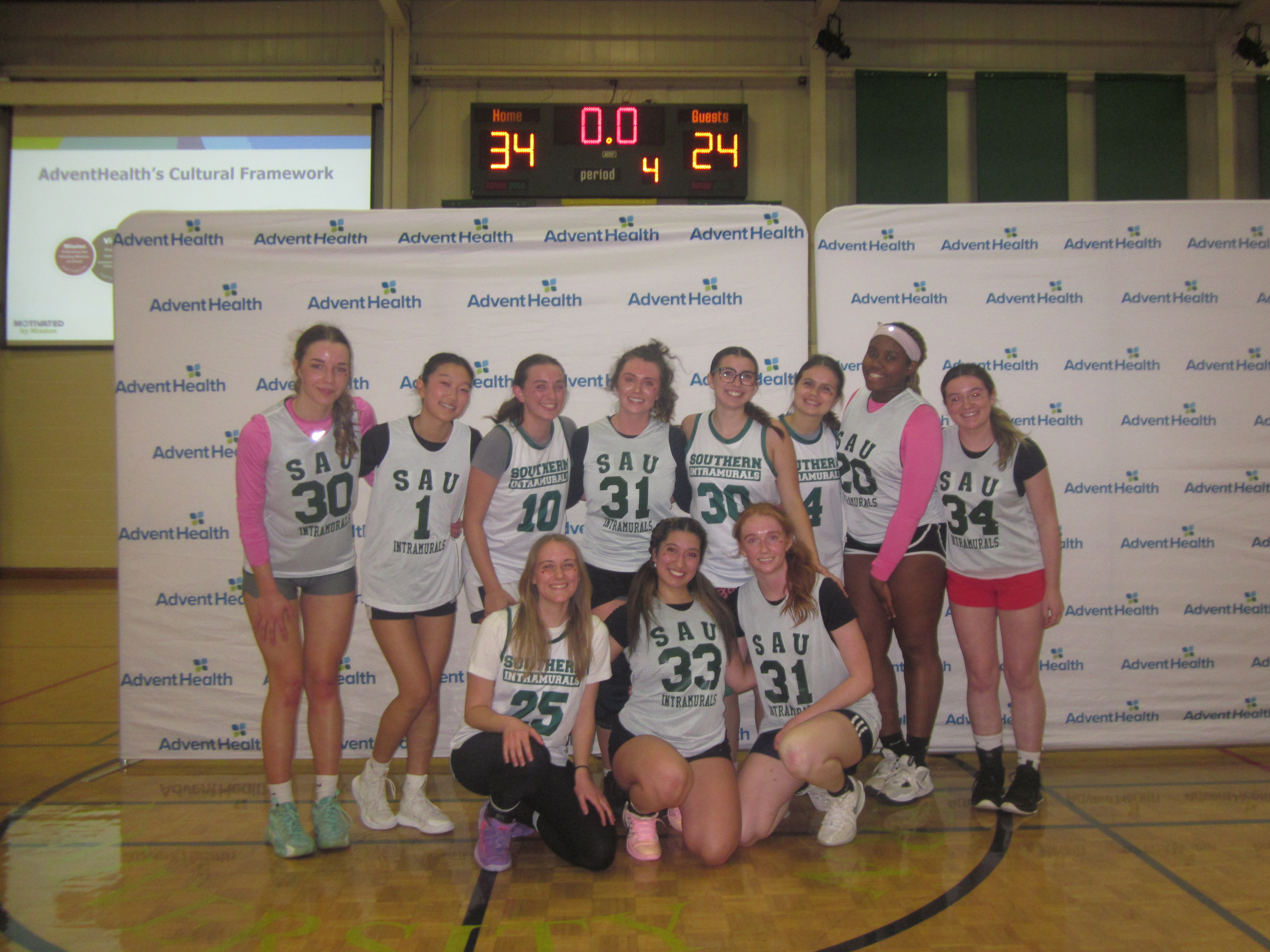 Basketball posing on a court after winning the championship