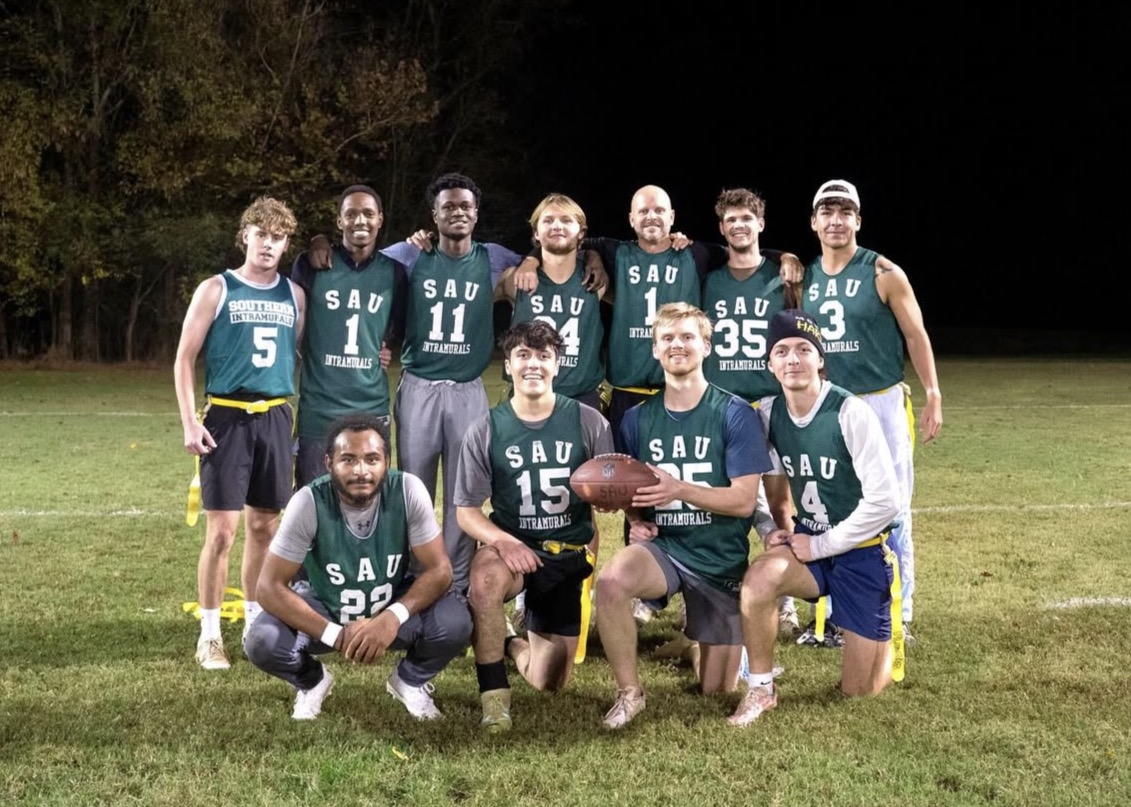 Blitzcraig posing on a softball field after winning the championship