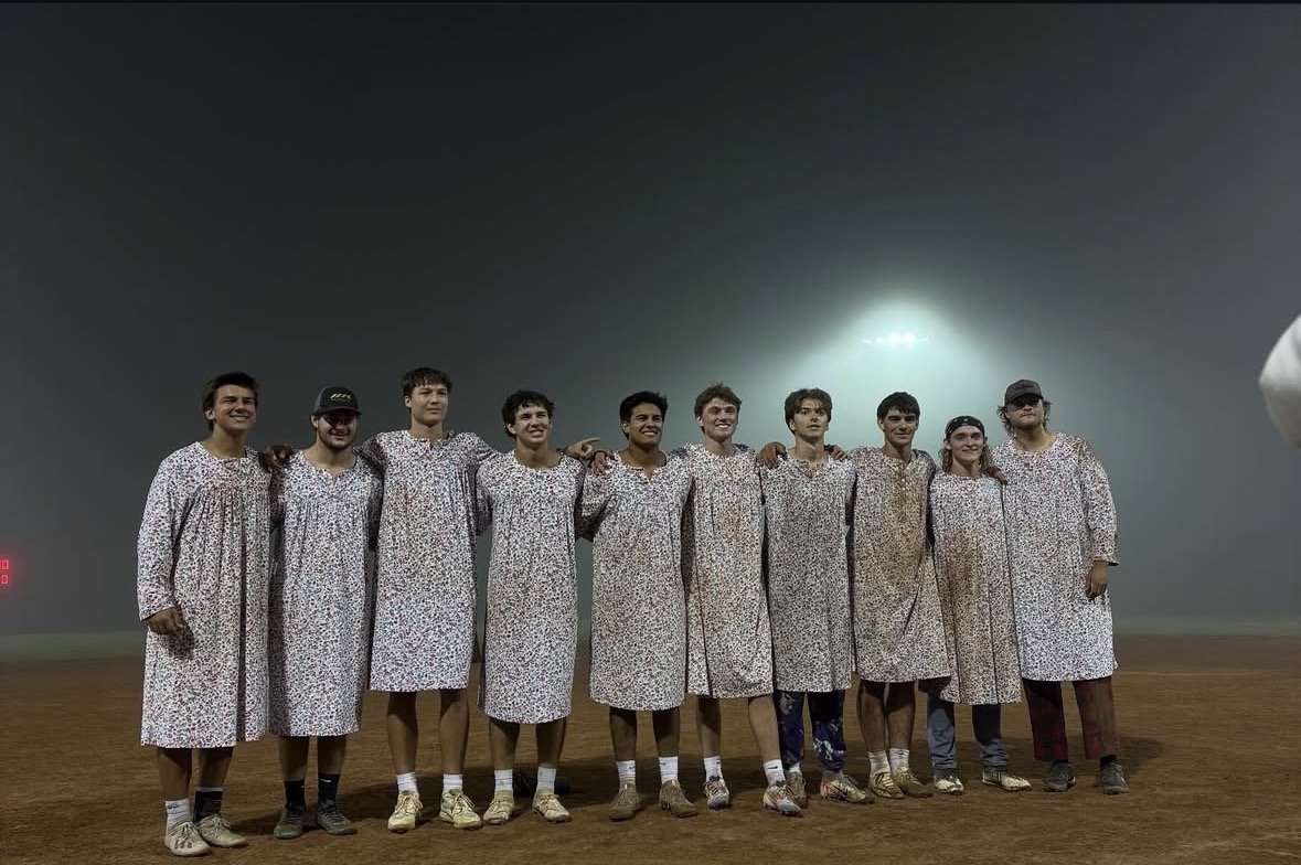 LetAndrewHit posing on a softball field after winning the championship