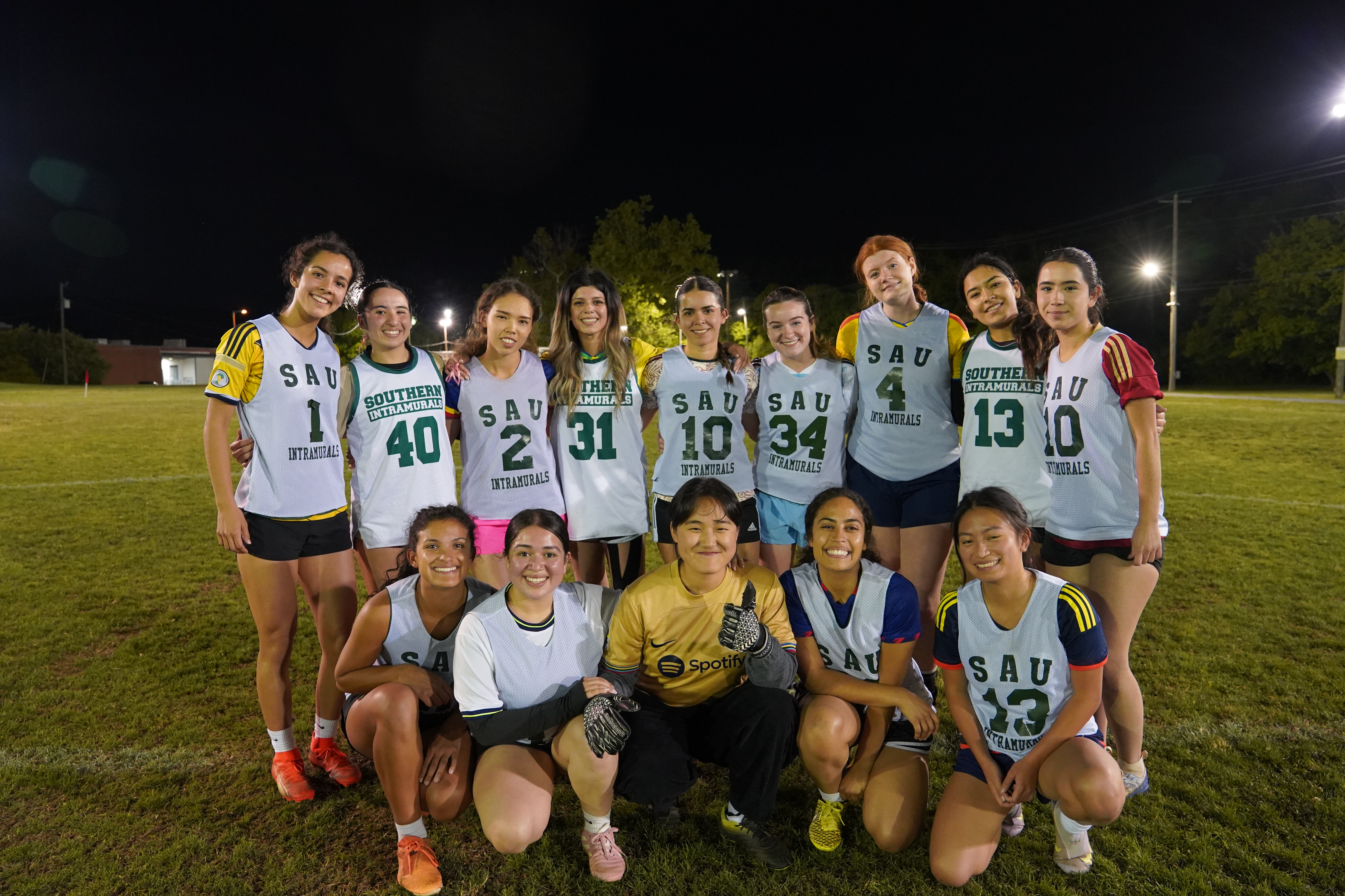 Uniscorns posing on a field after winning the championship