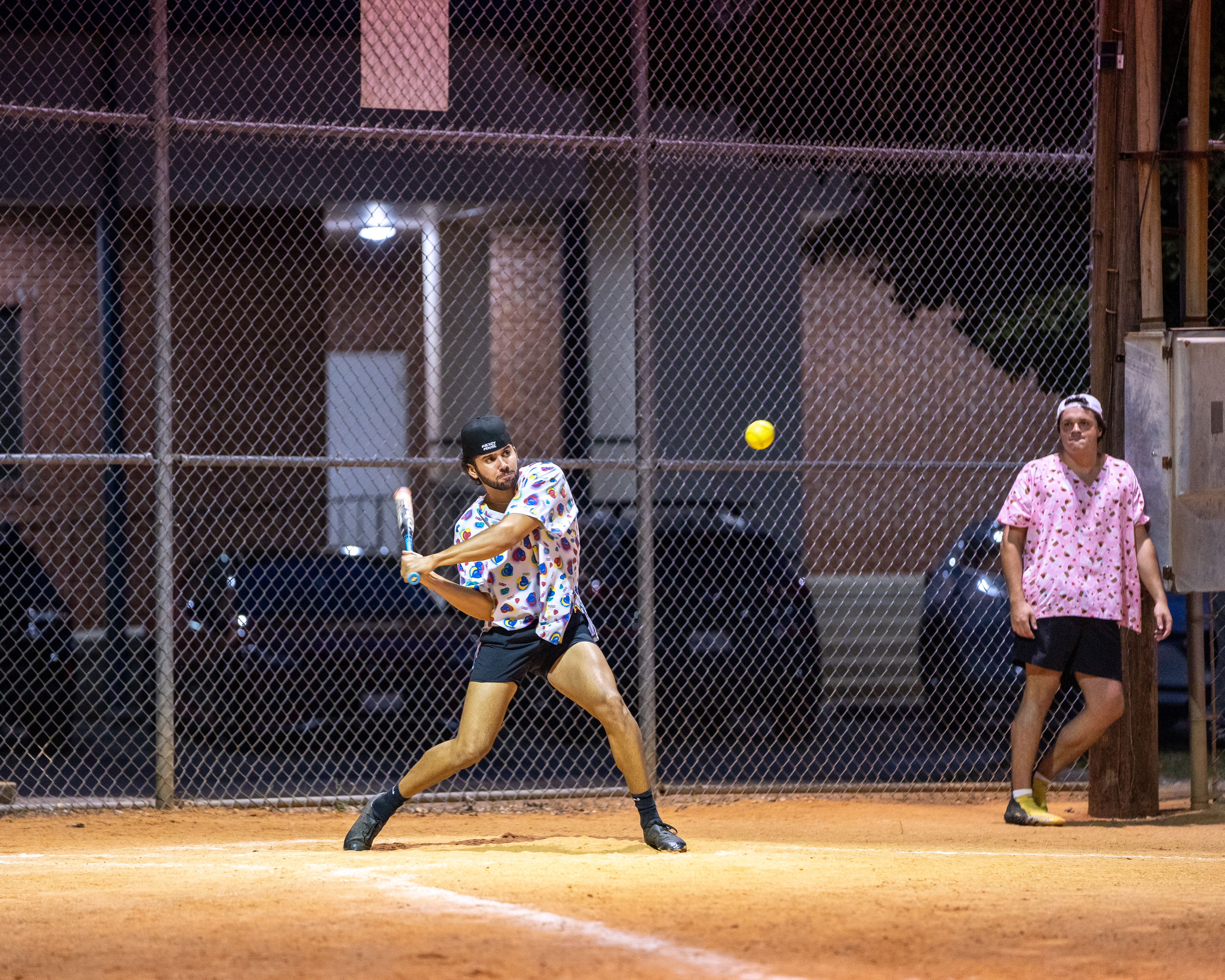 Softball player making a swing at home plate