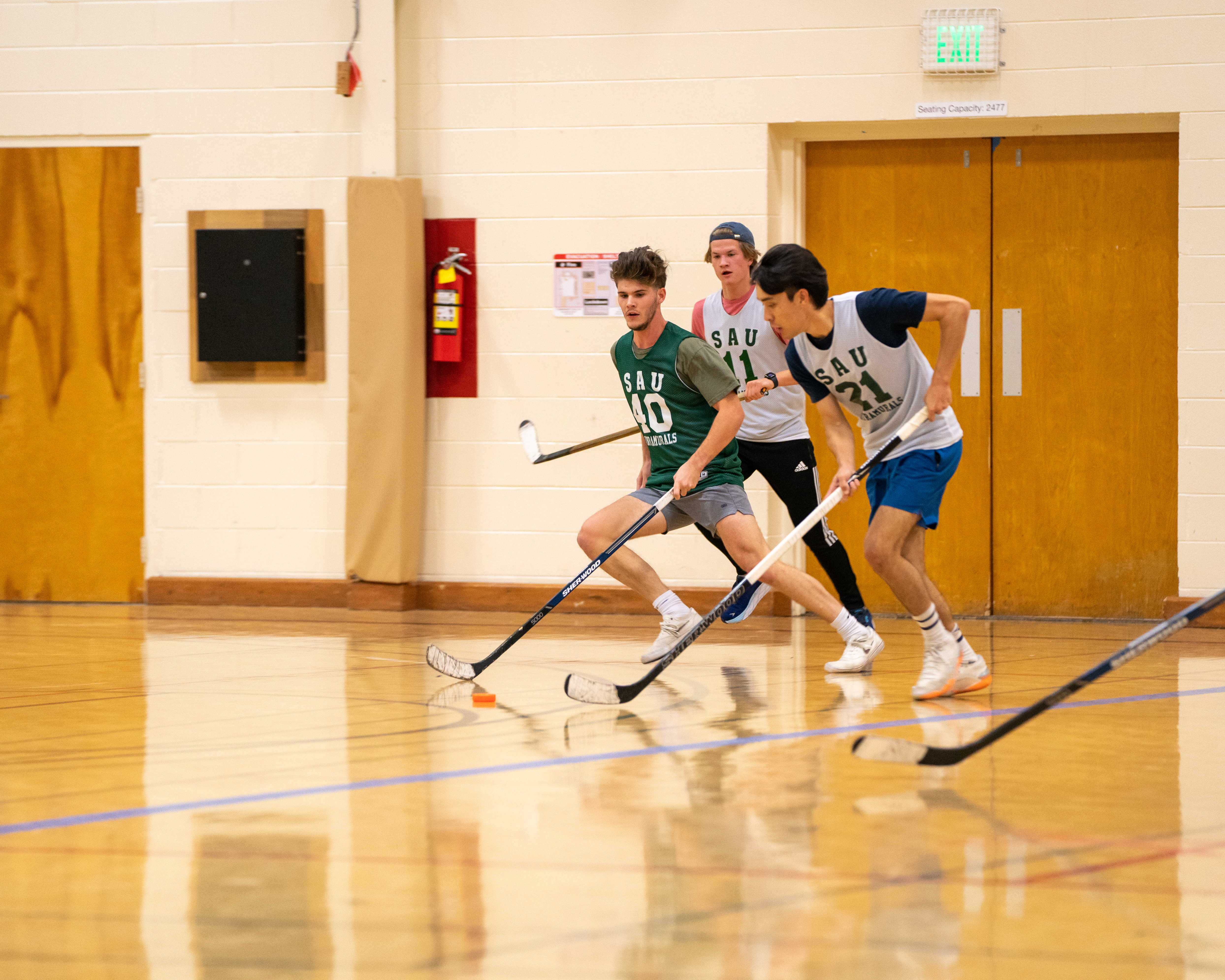 Southern students playing intramural floor hockey