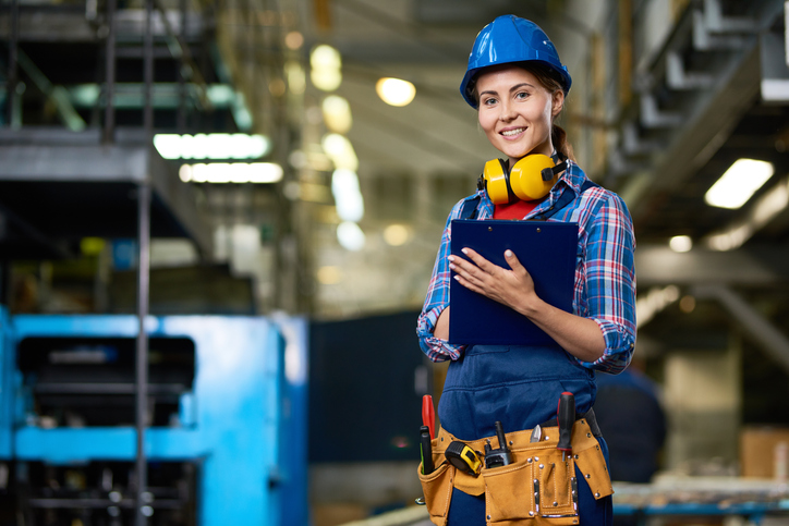 Woman in hard hat and construction gear
