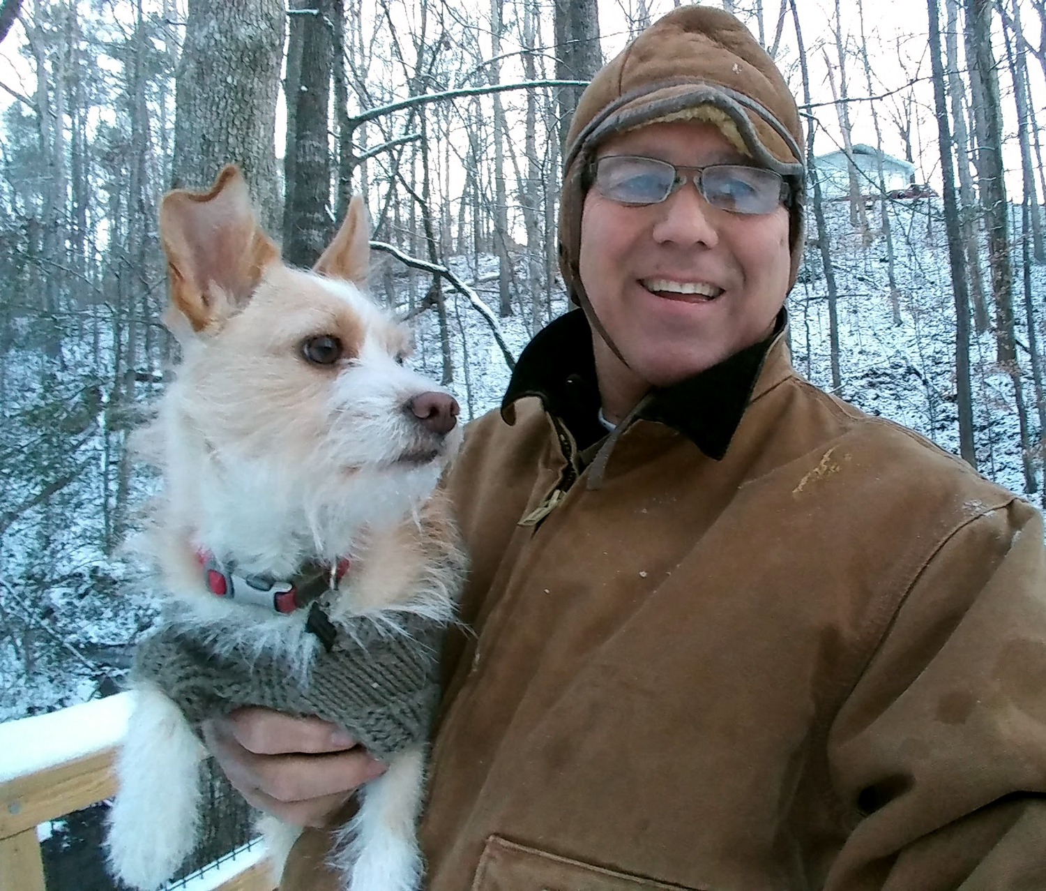 Charlie, the Blond Rat Terrier and Maltese mix is pictured alongside Harold Mayer on a snowy day.