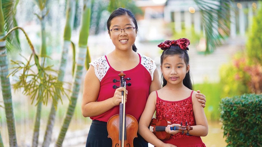 A violin teacher with her students