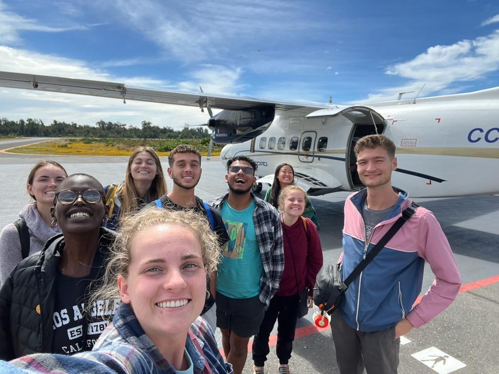 Bolivia group selfie in front of plane