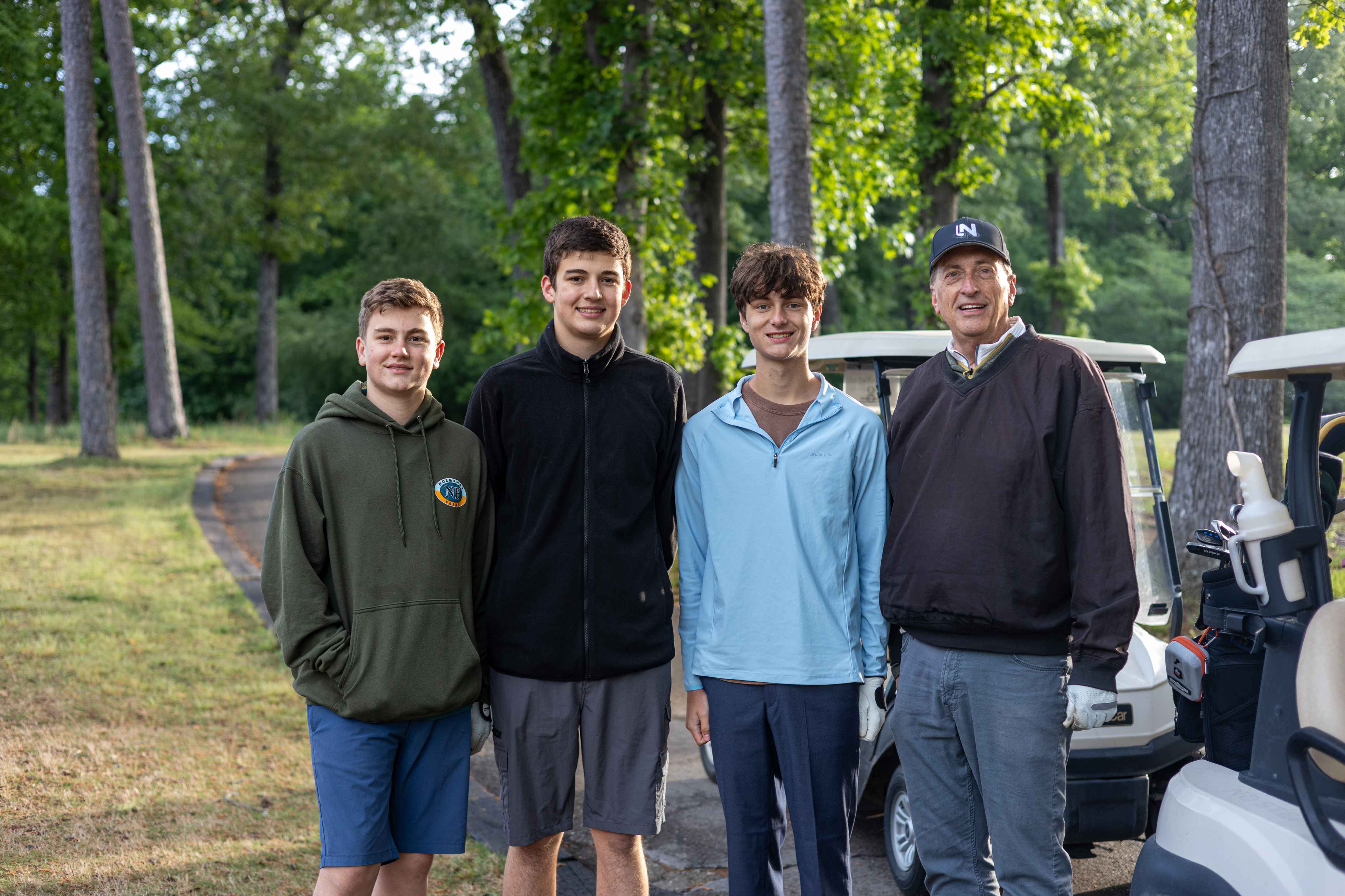 four golfers posing 