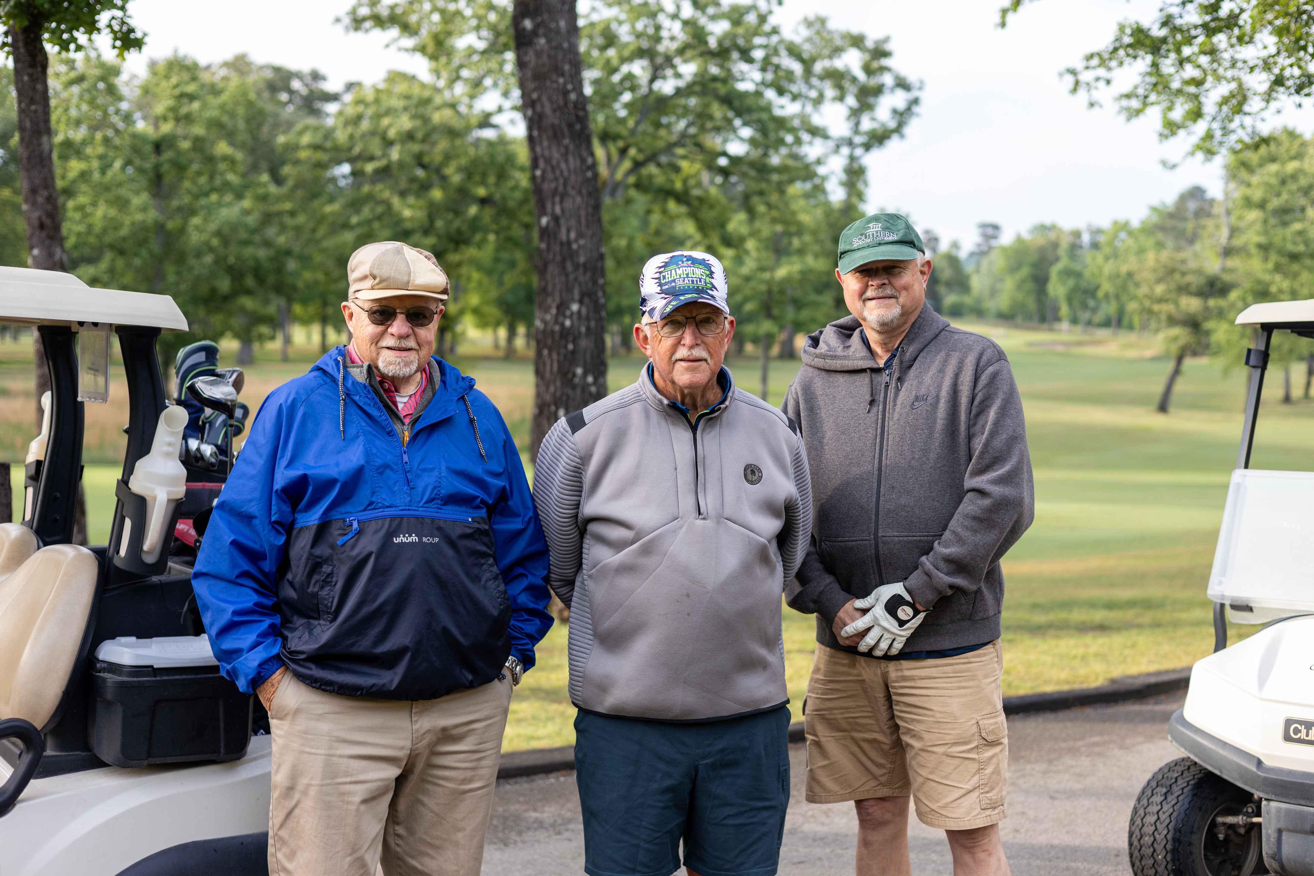 three golfers posing 