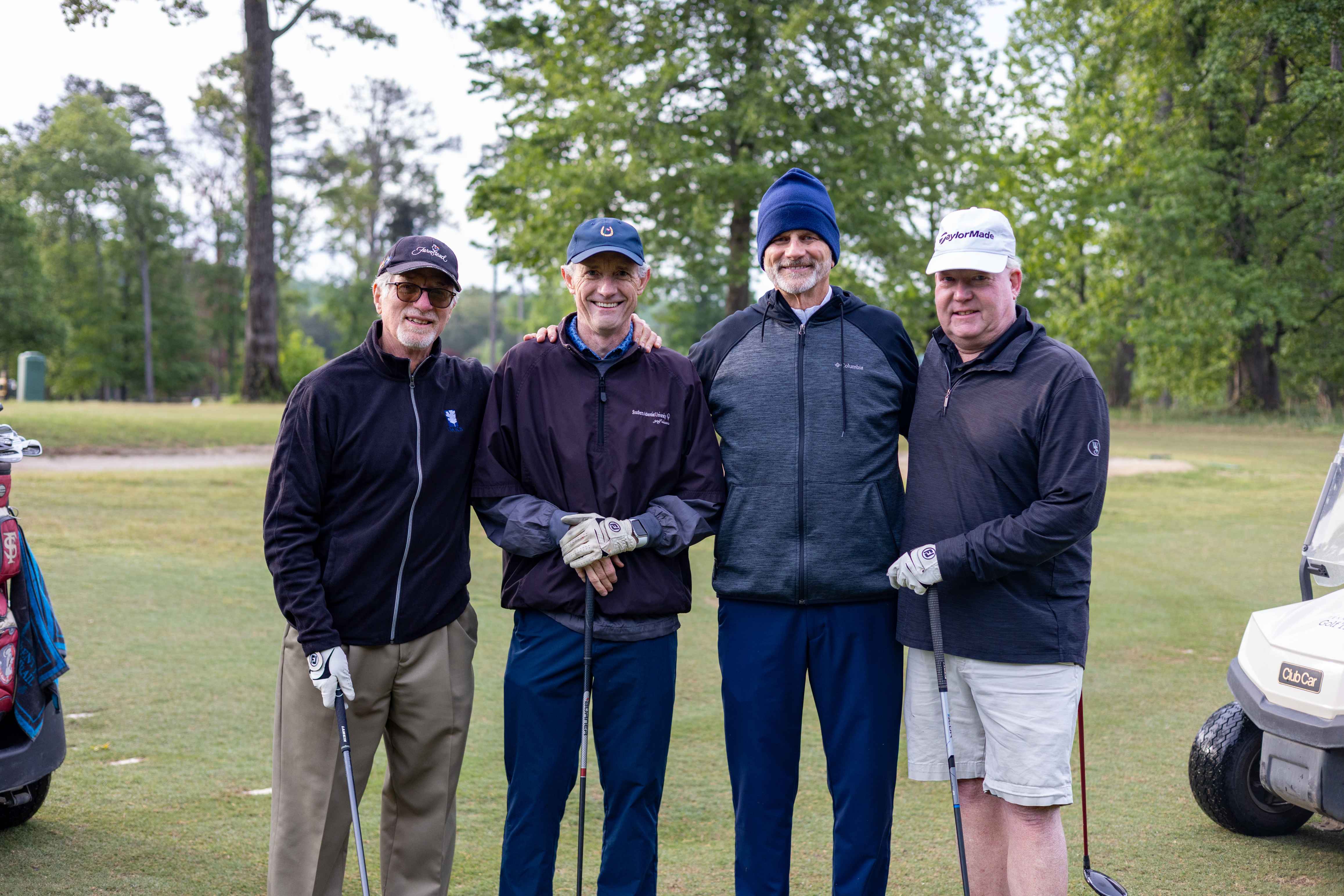 four golfers posing 