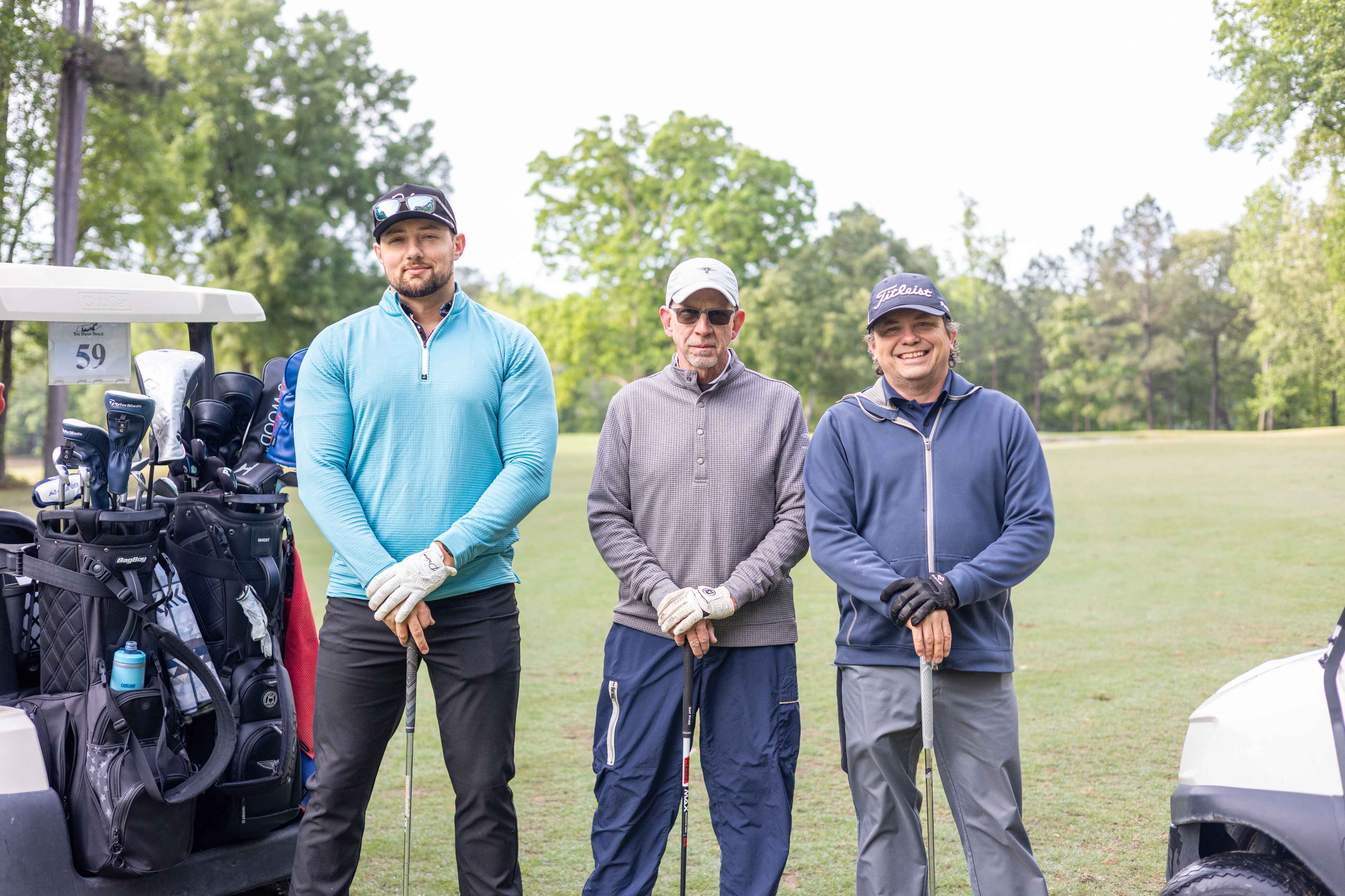 three golfers posing 