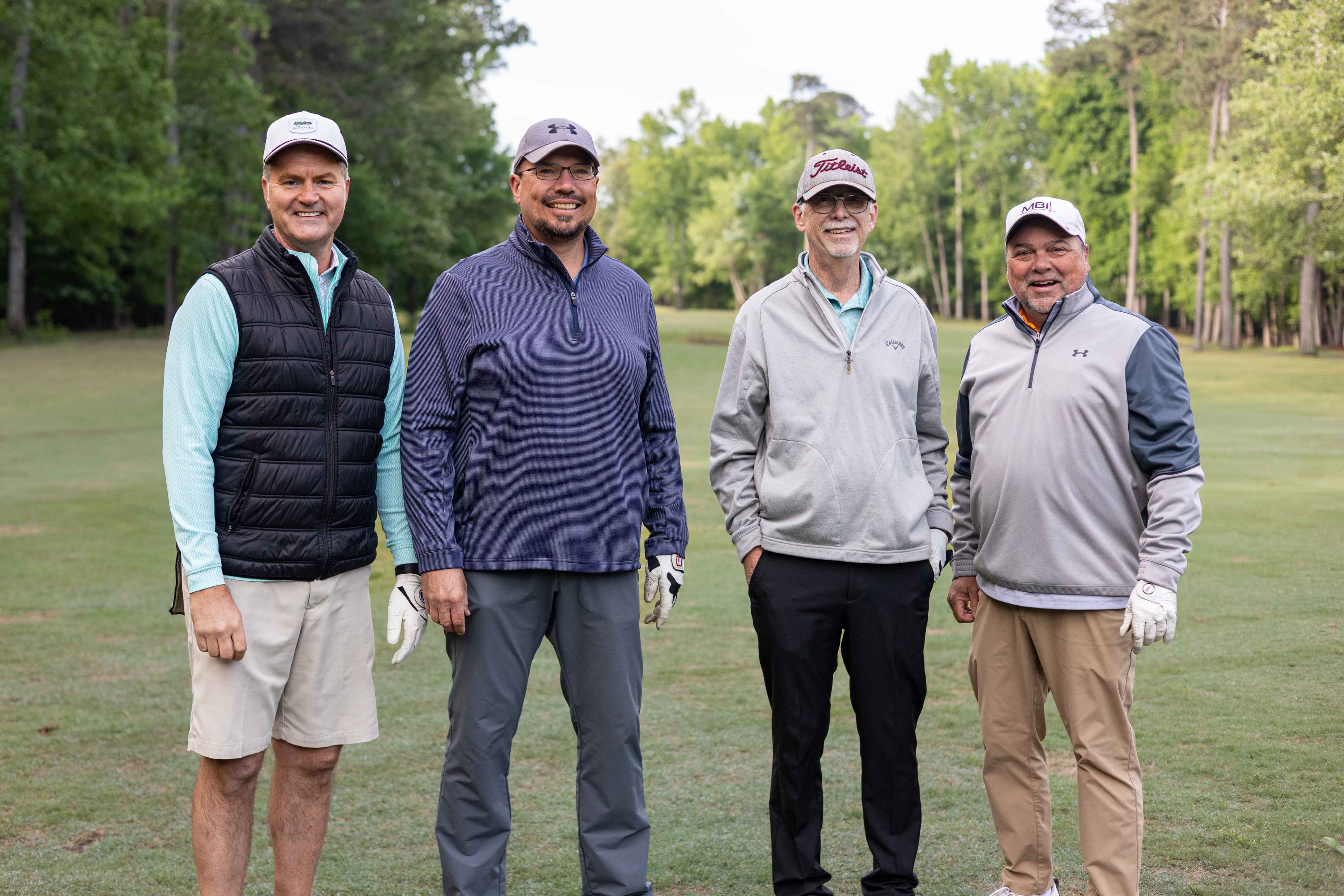 four golfers posing 