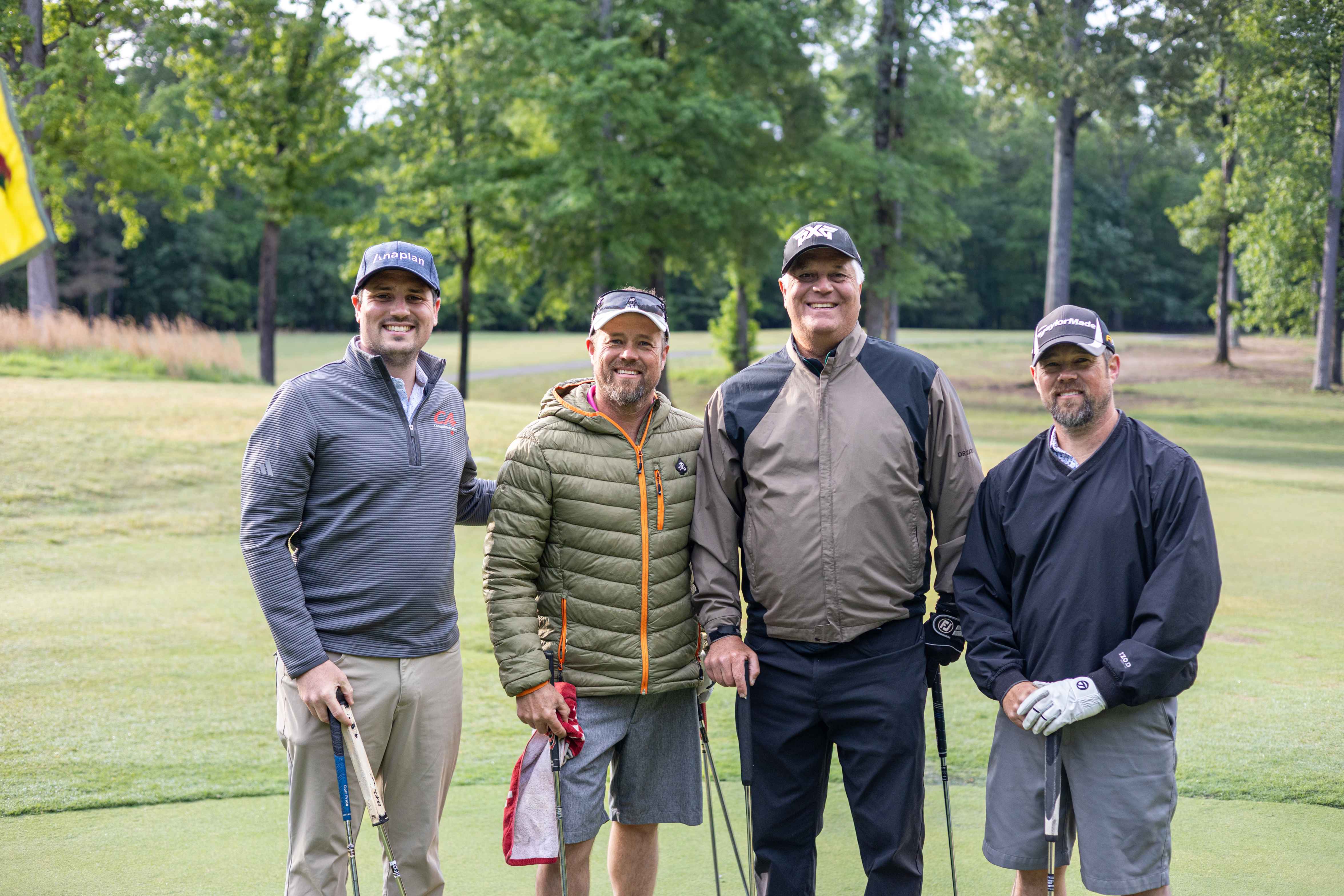 four golfers posing 
