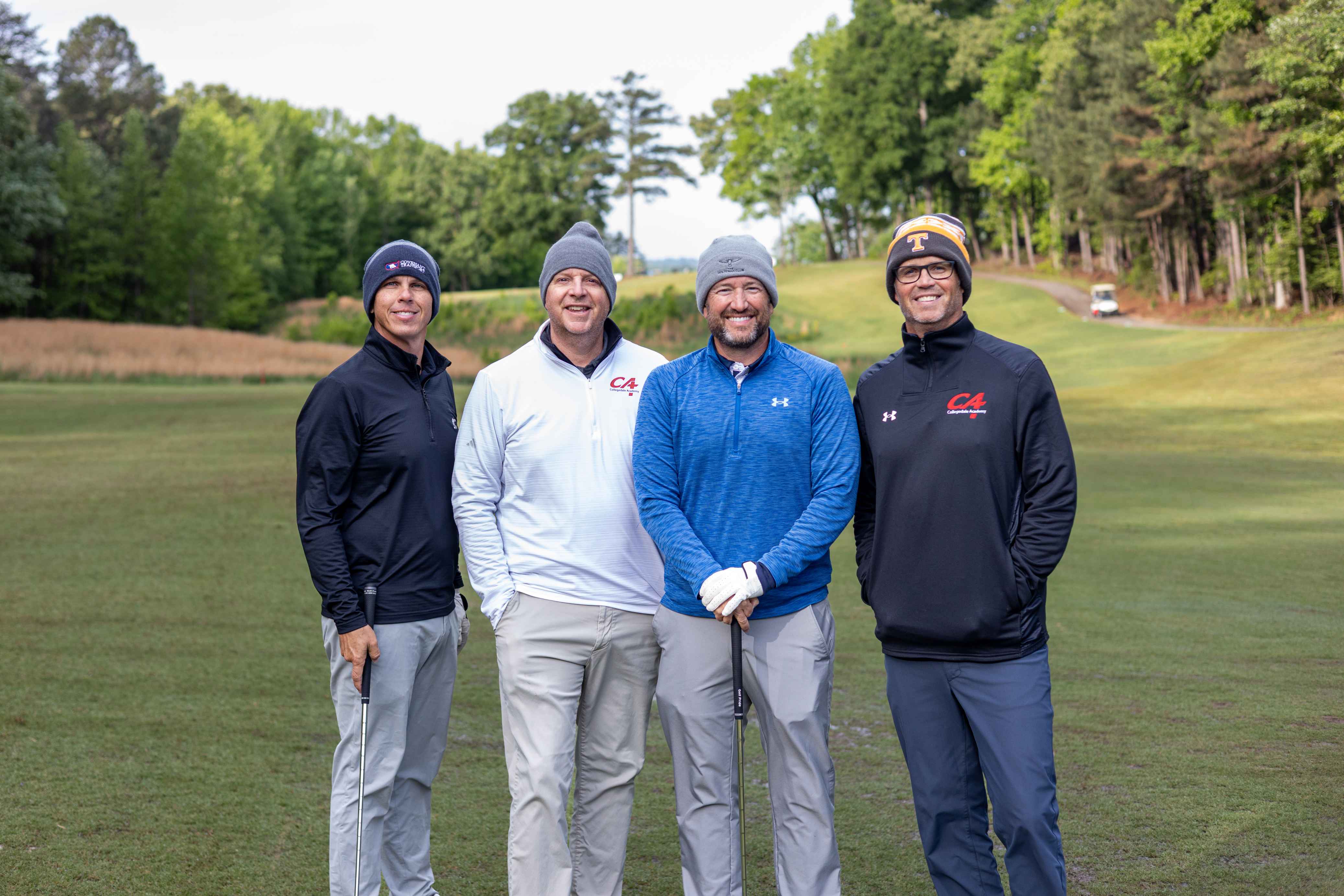 four golfers posing 