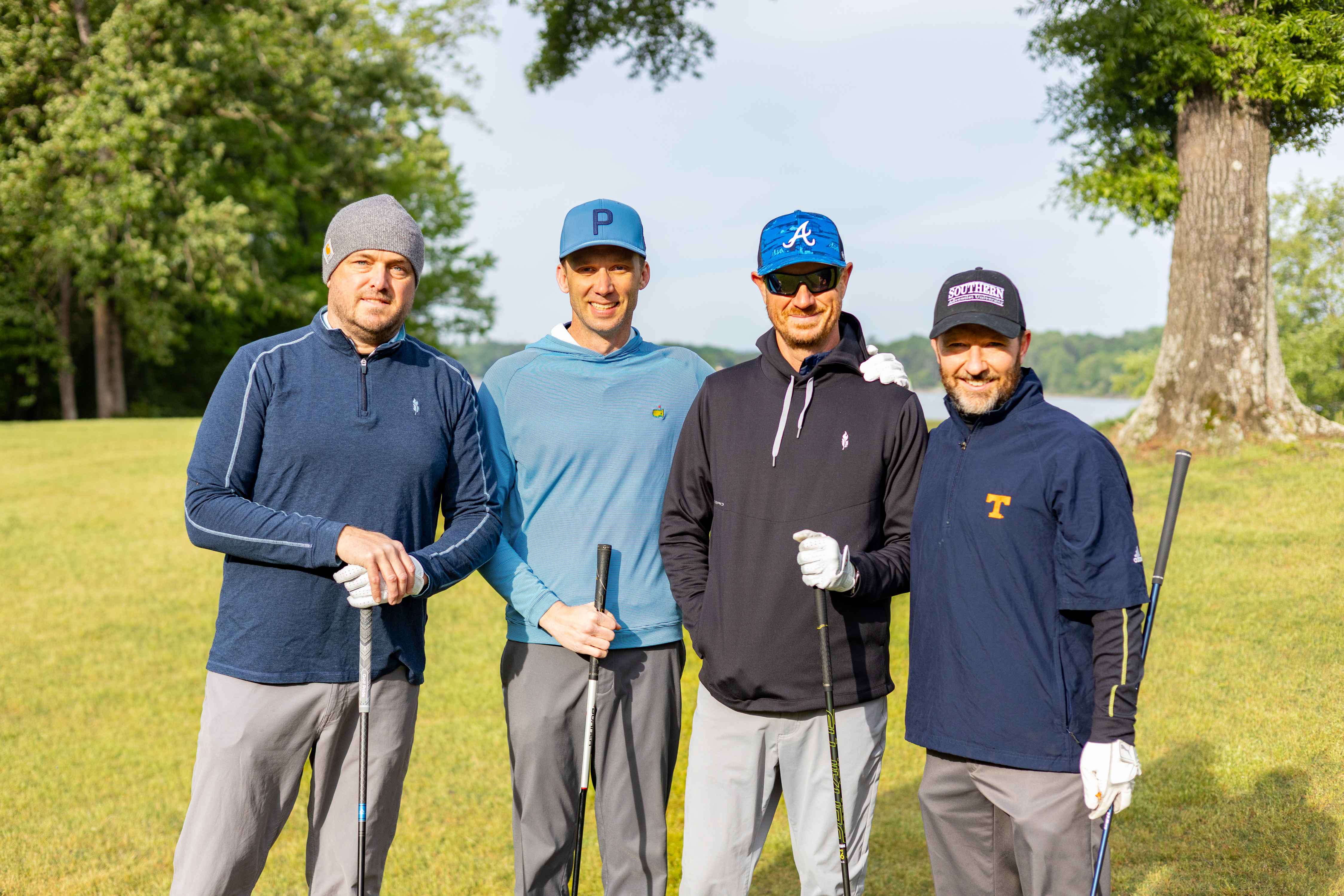 four golfers posing 