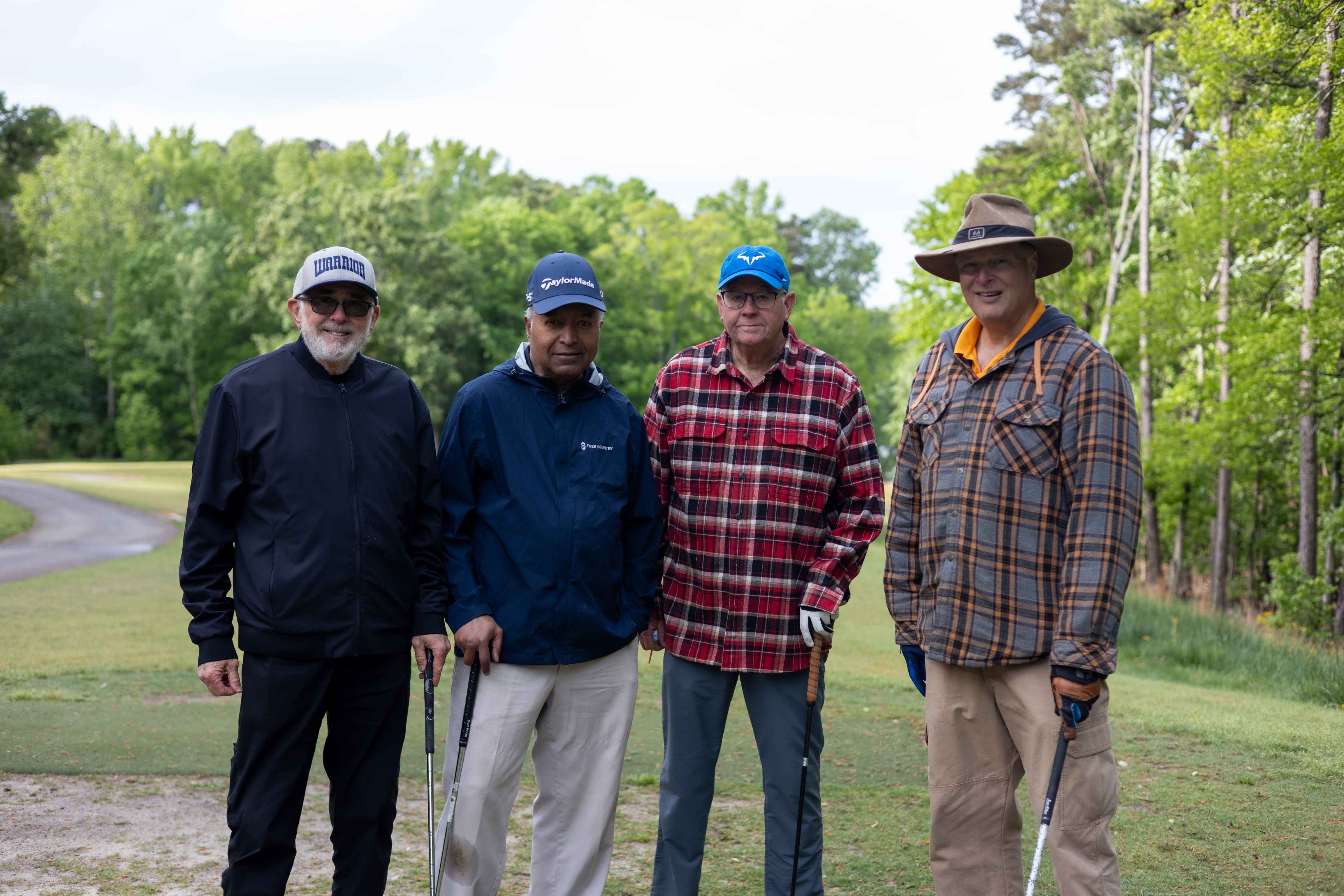 four golfers posing 