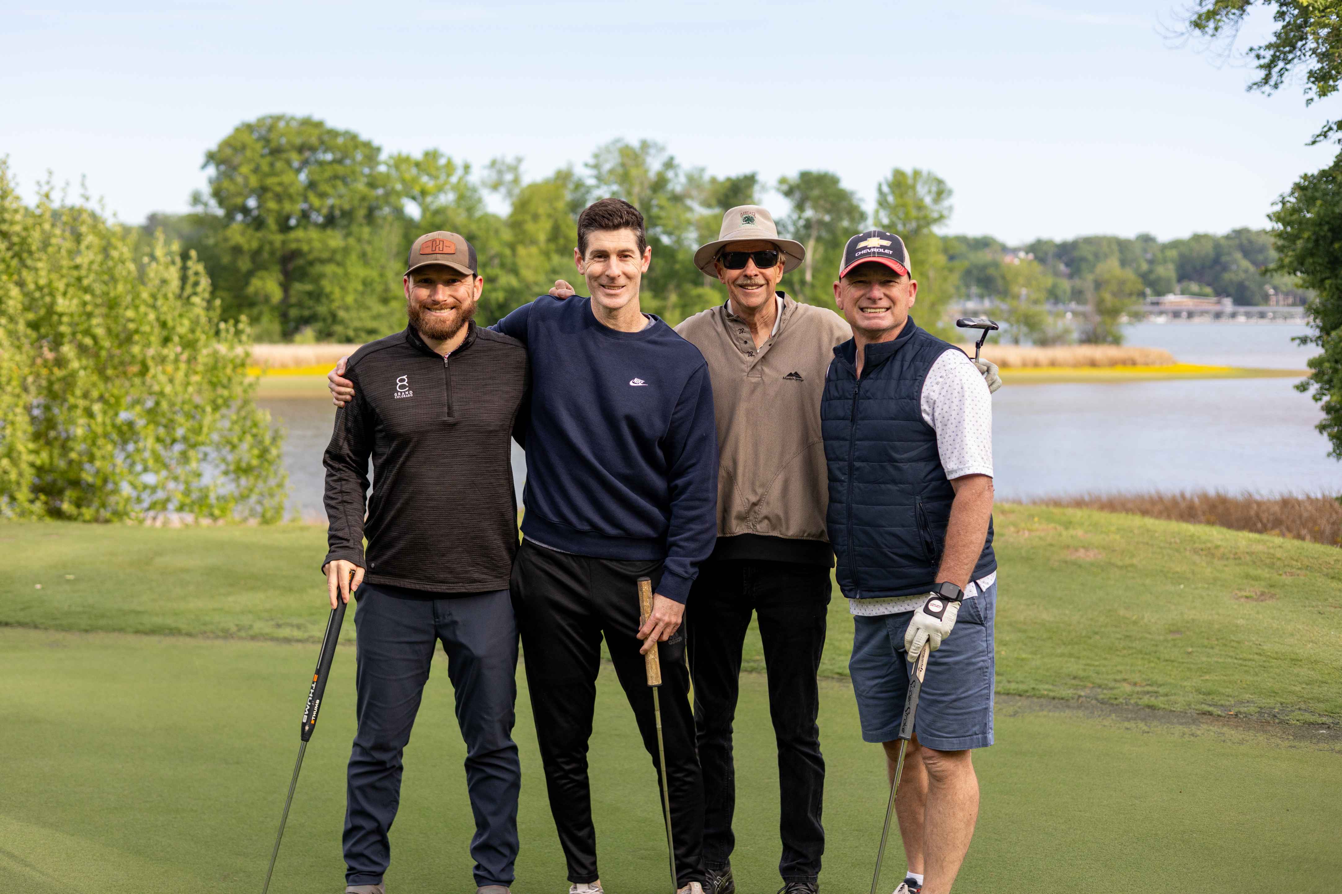 four golfers posing 