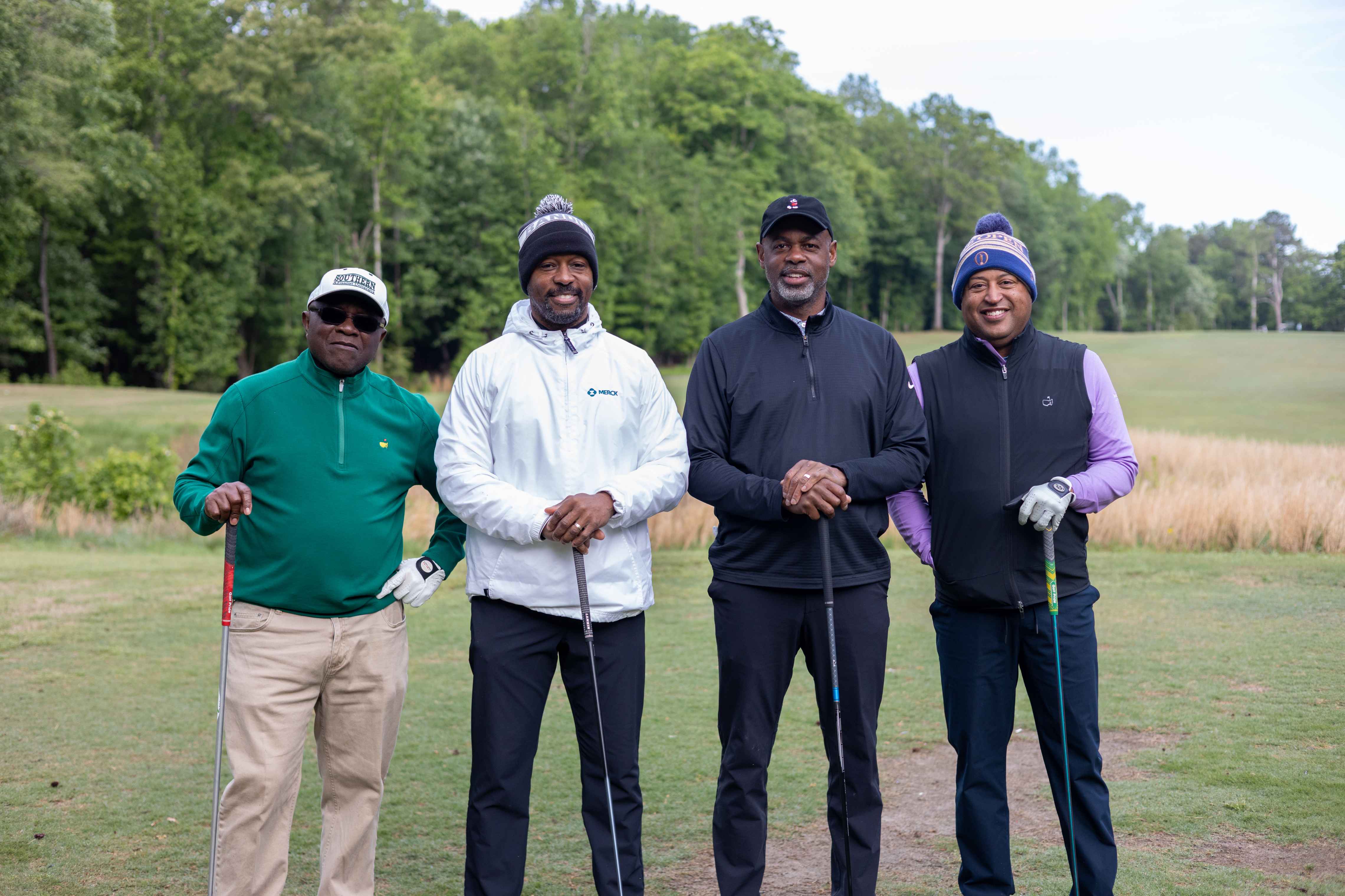 four golfers posing 