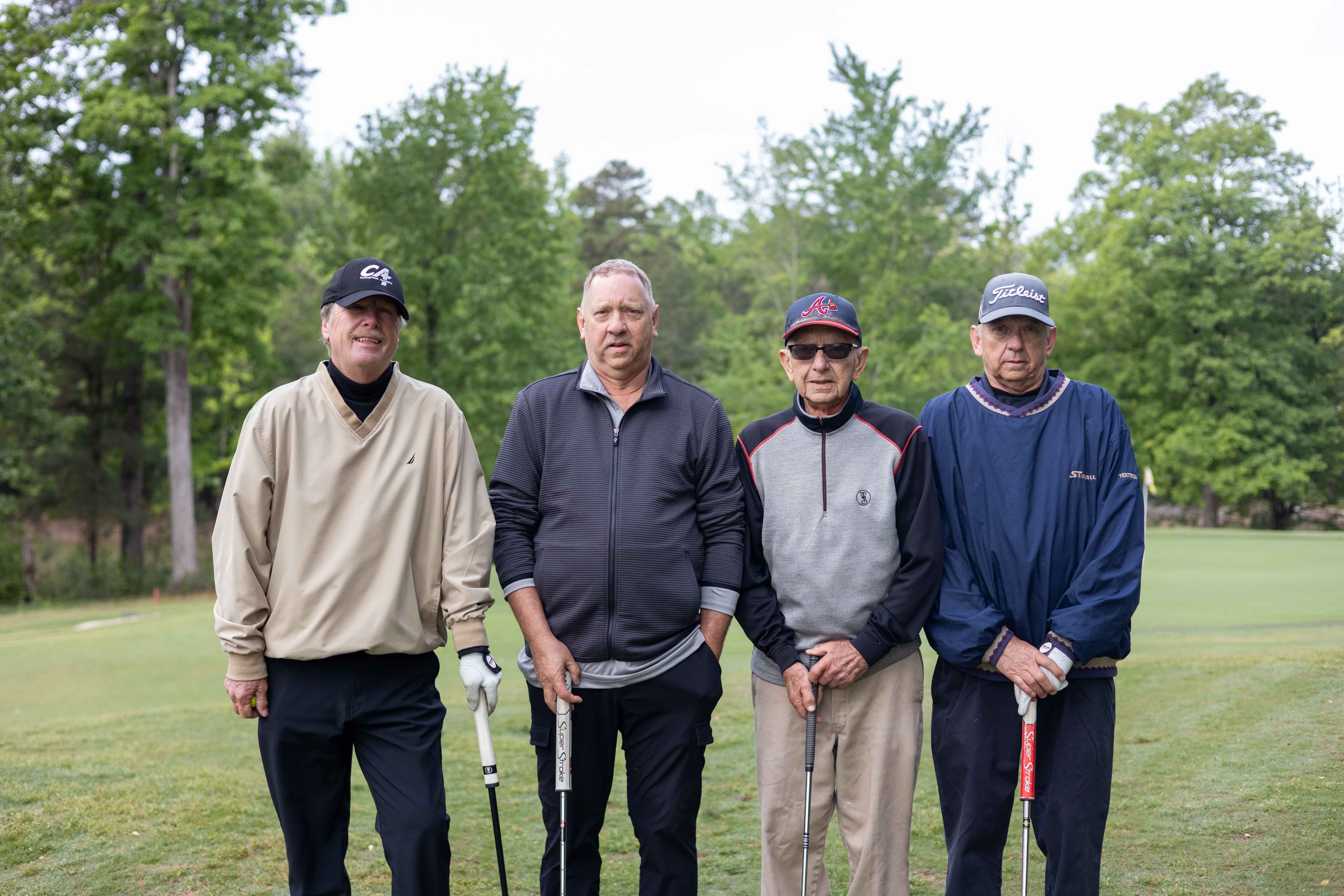 four golfers posing 