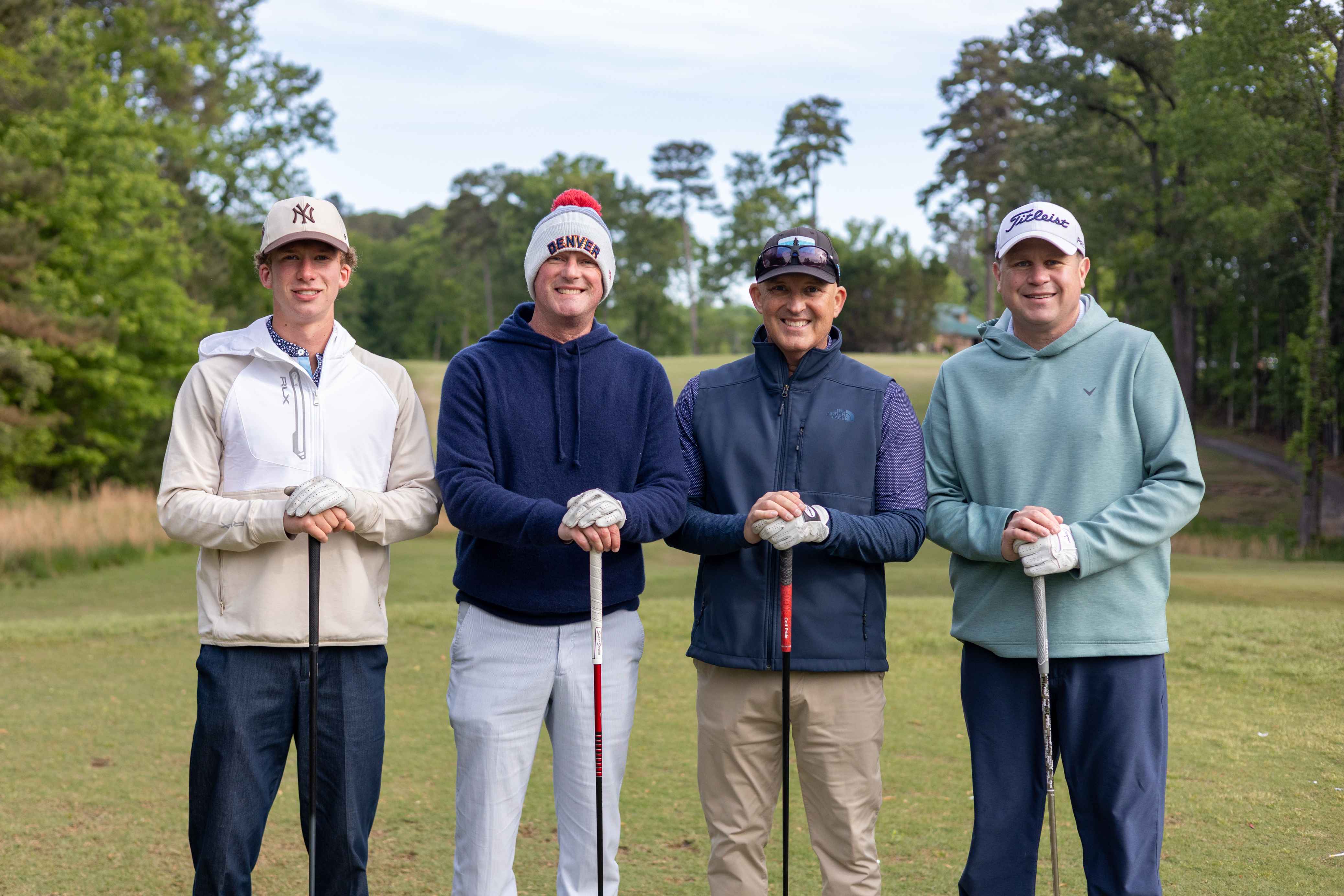 four golfers posing 