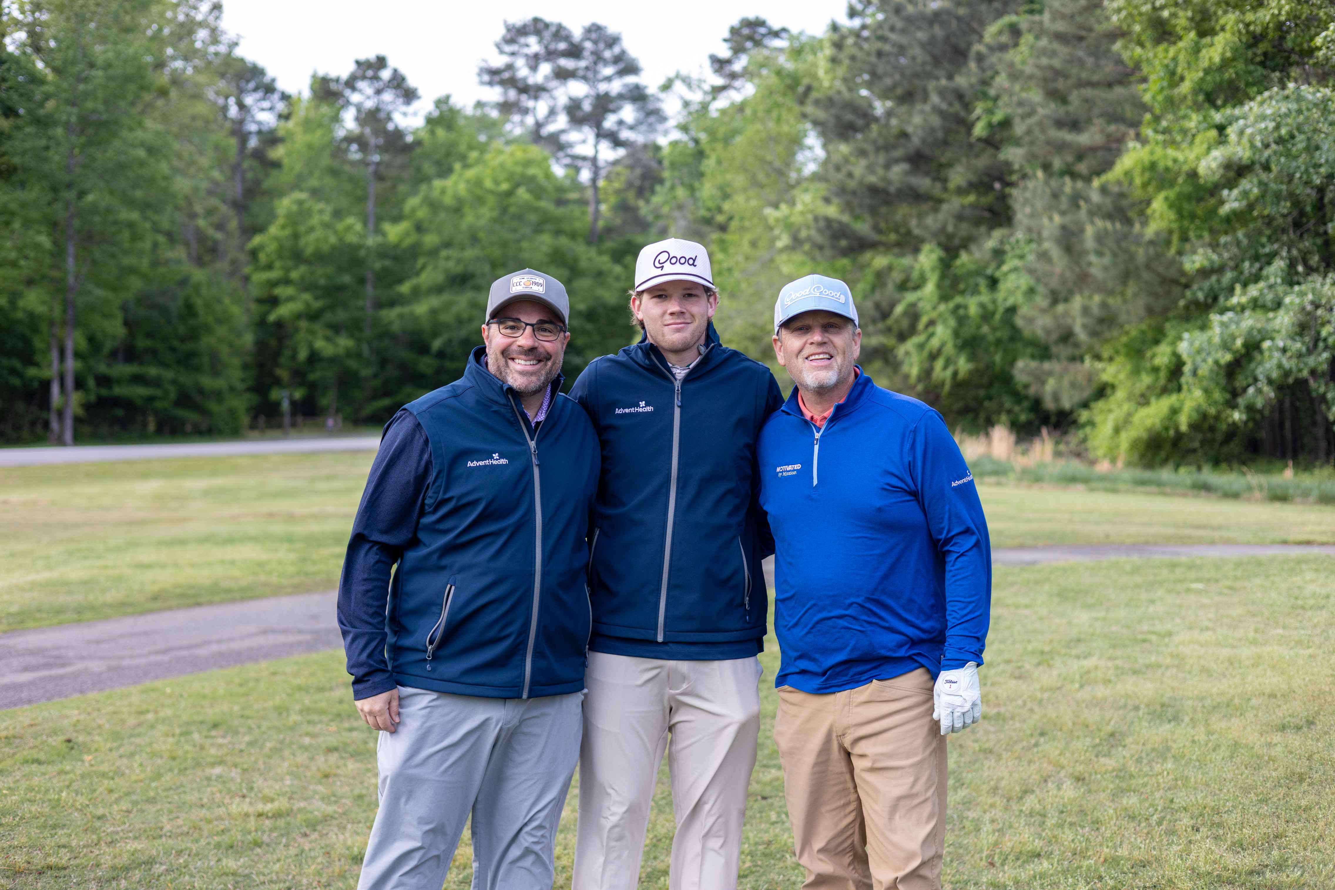 three golfers posing 