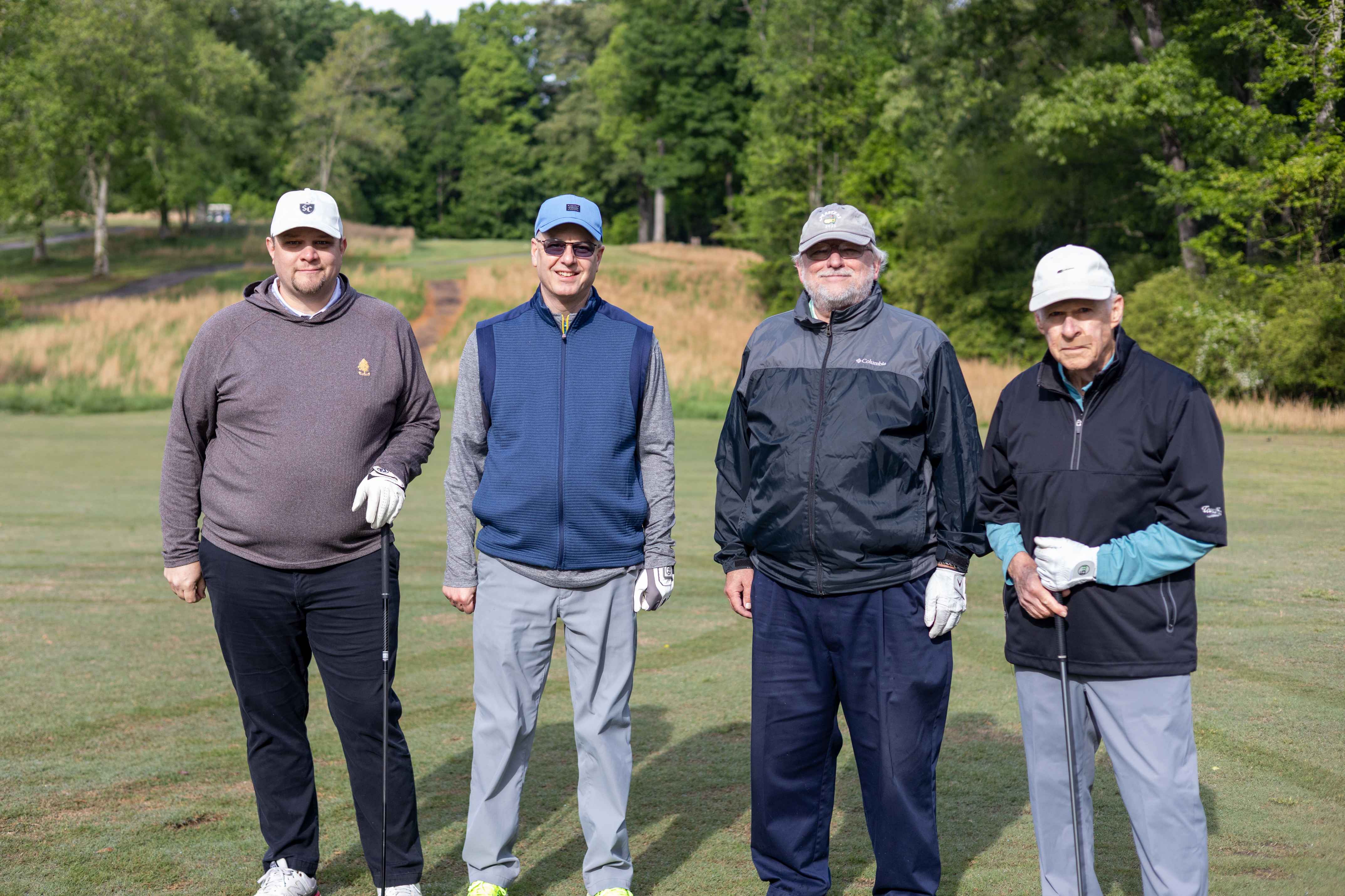 four golfers posing 
