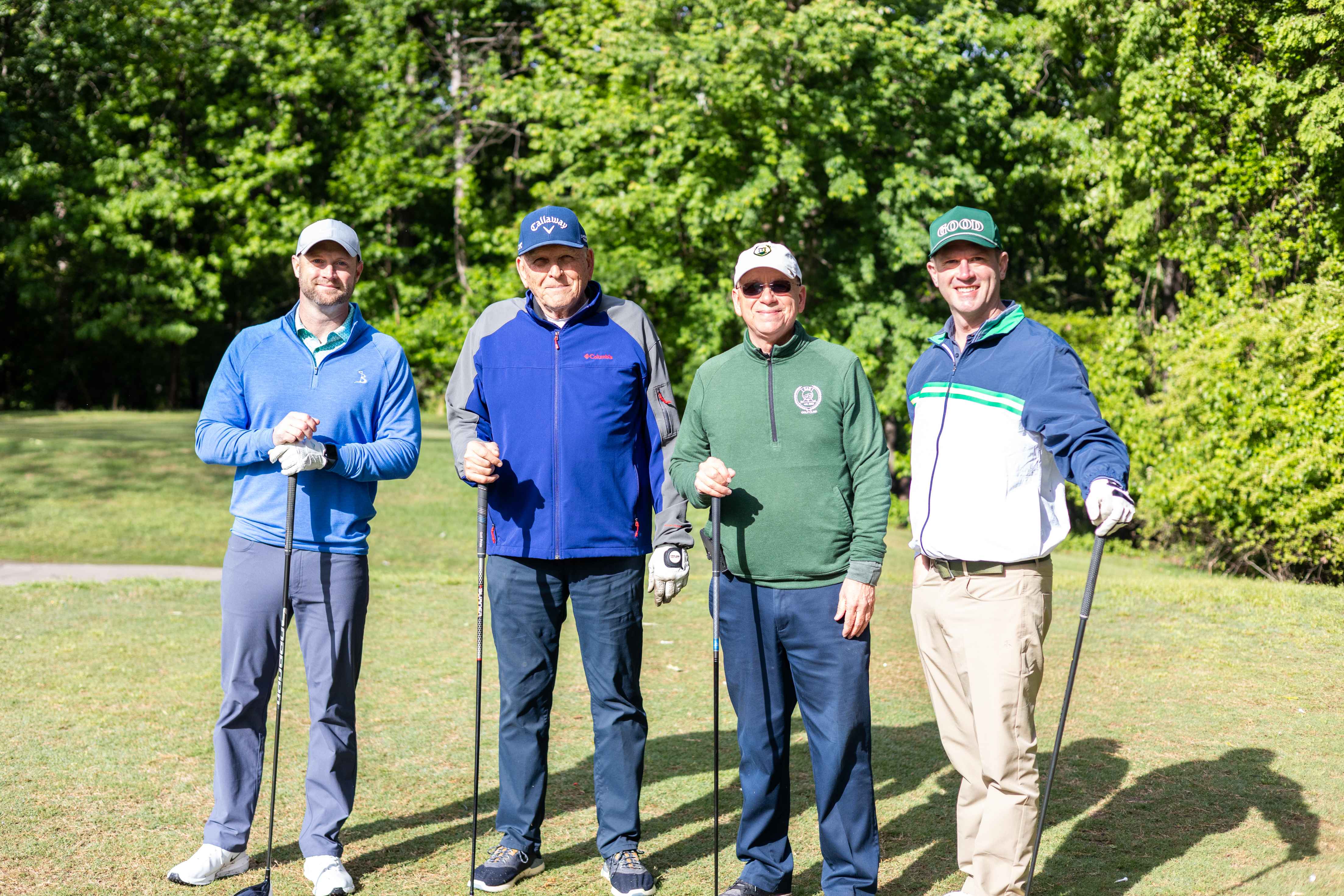 four golfers posing 