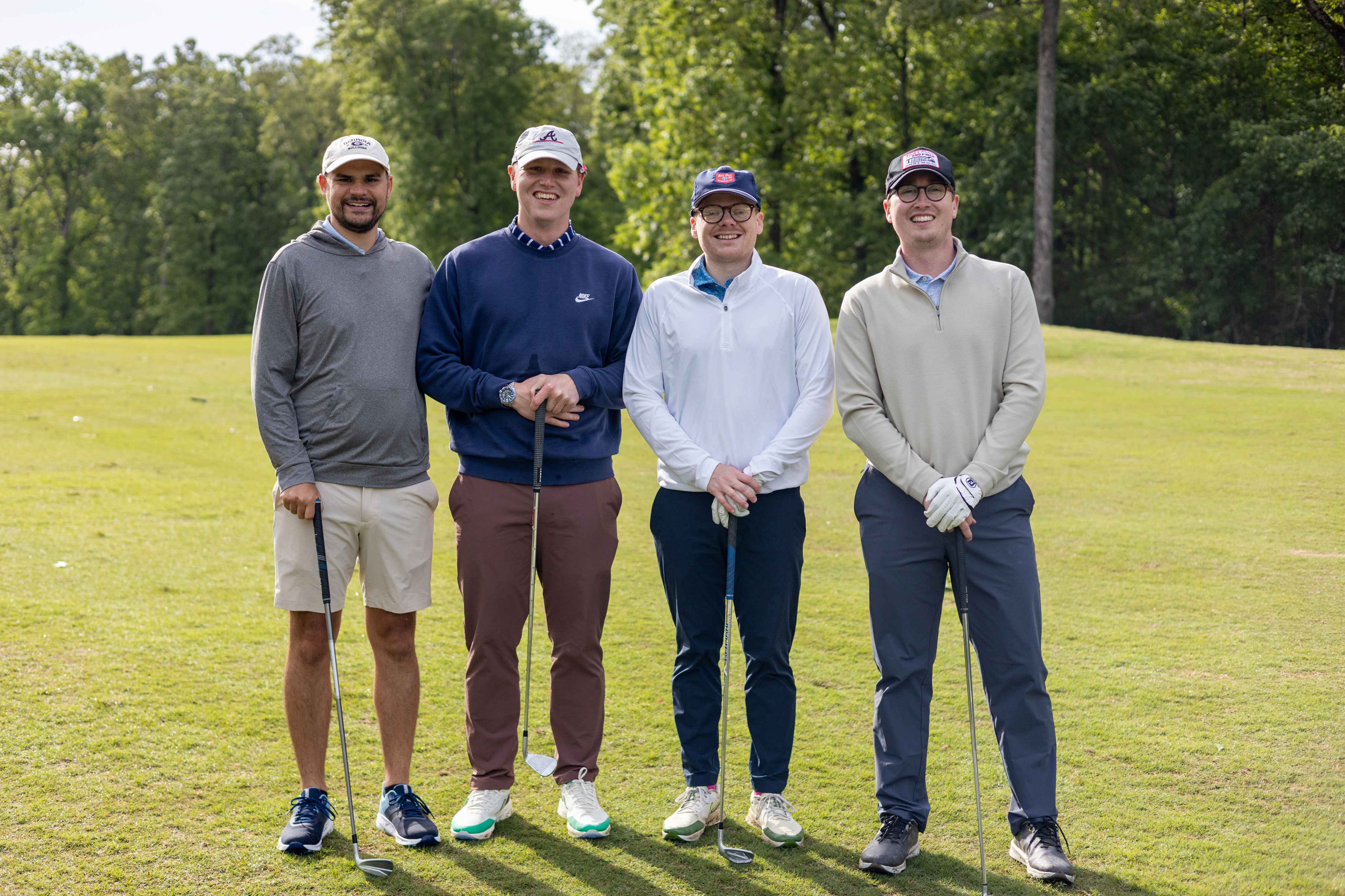 four golfers posing 