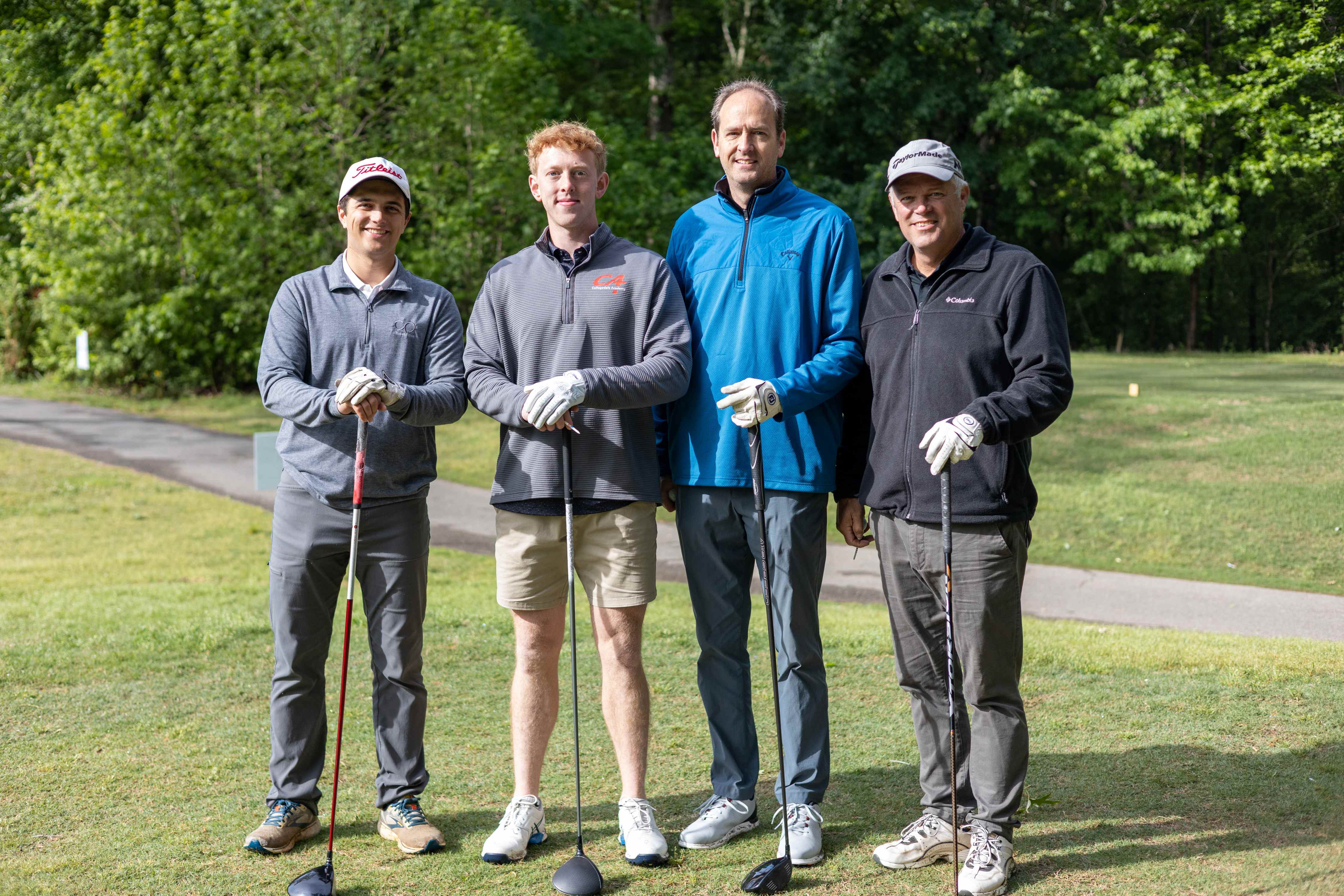 four golfers posing 