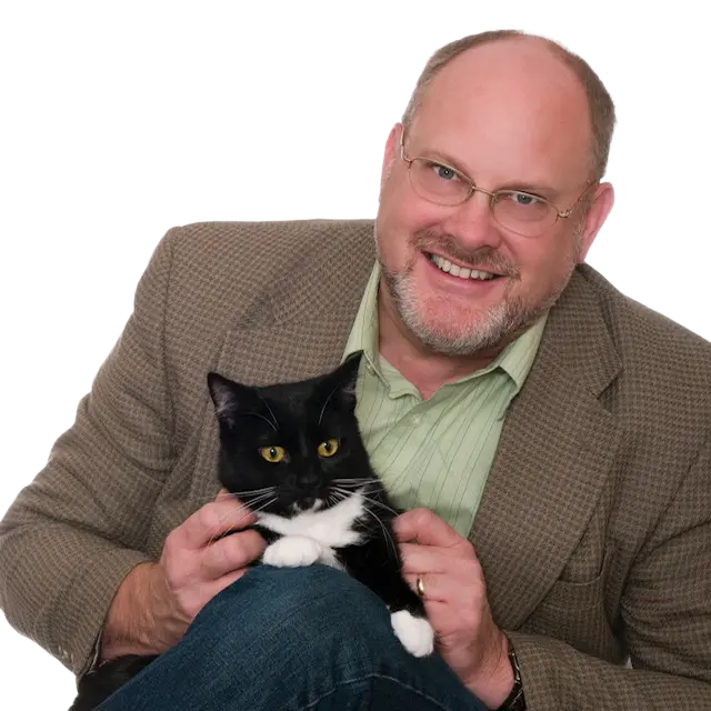 Bruce Coston holding a cat in his lap