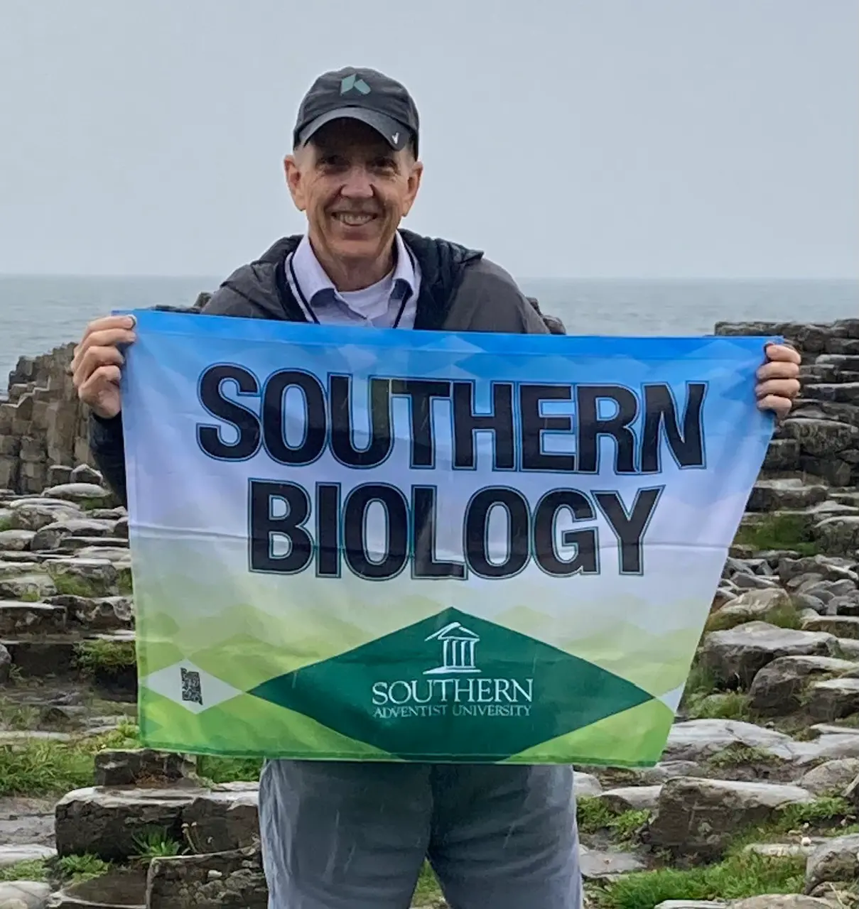 Rick Norskov holding a Southern Biology flag